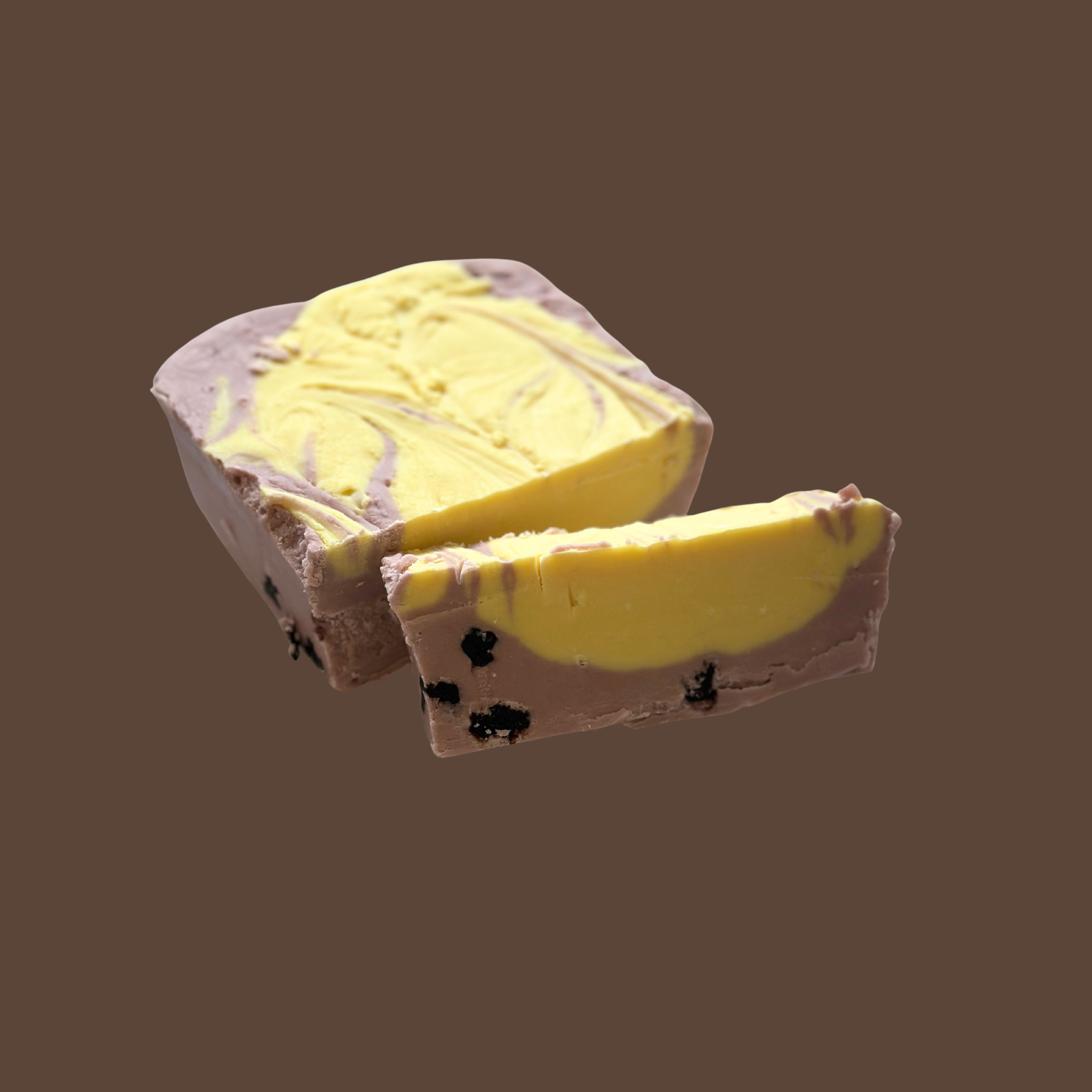 A piece of lemon blueberry fudge, set against a brown background.
