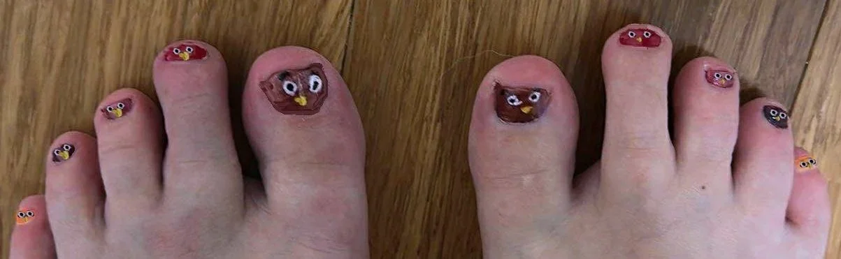 Toenails decorated with Angry Birds characters painted on each toenail.