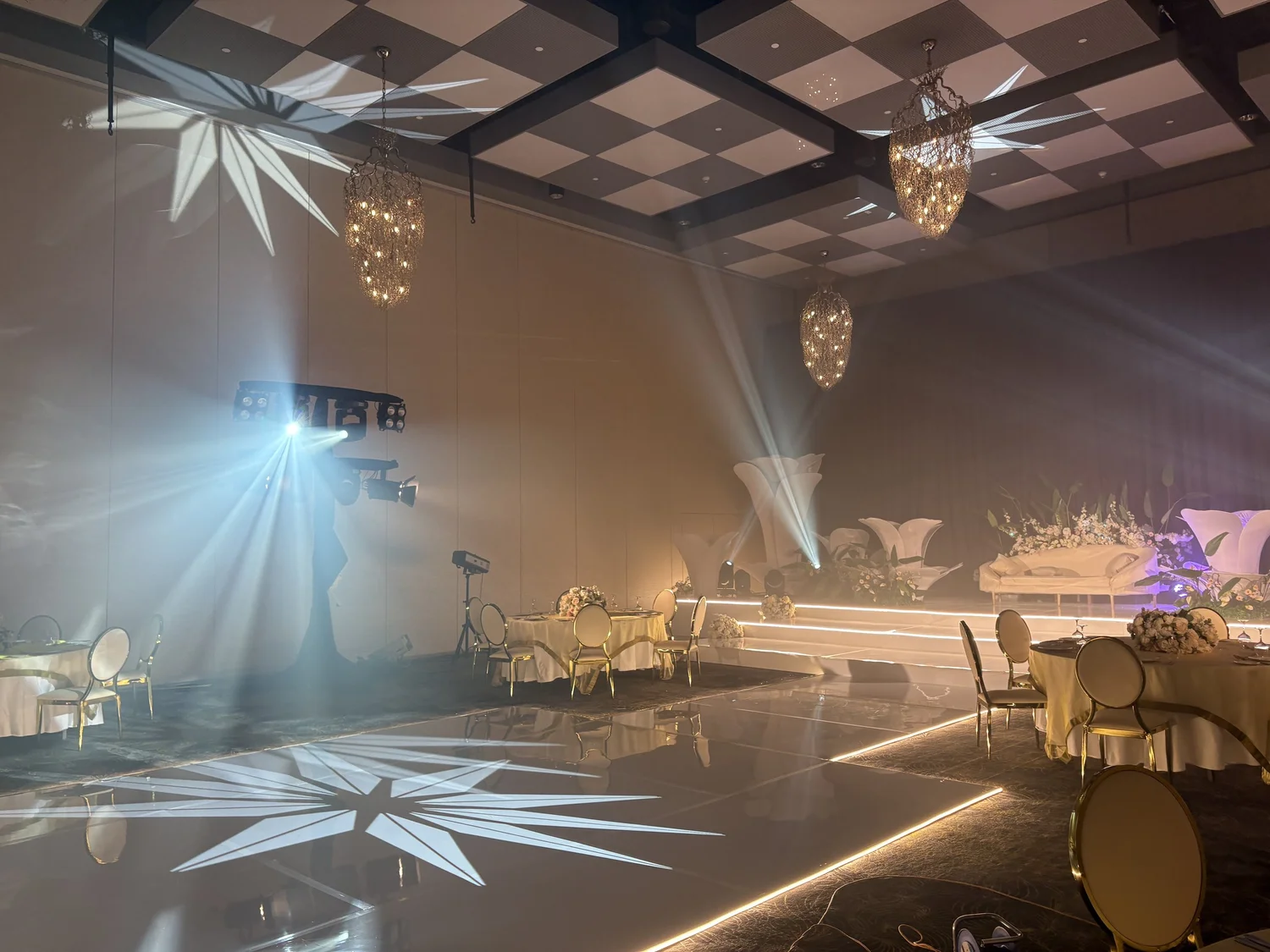 Star-pattern gobo projections on a wedding reception wall
