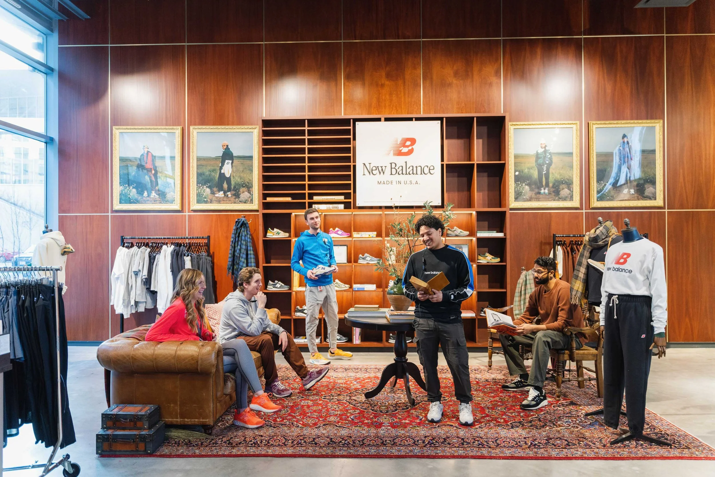 Staff members convene and pose inside a New Balance retail store.