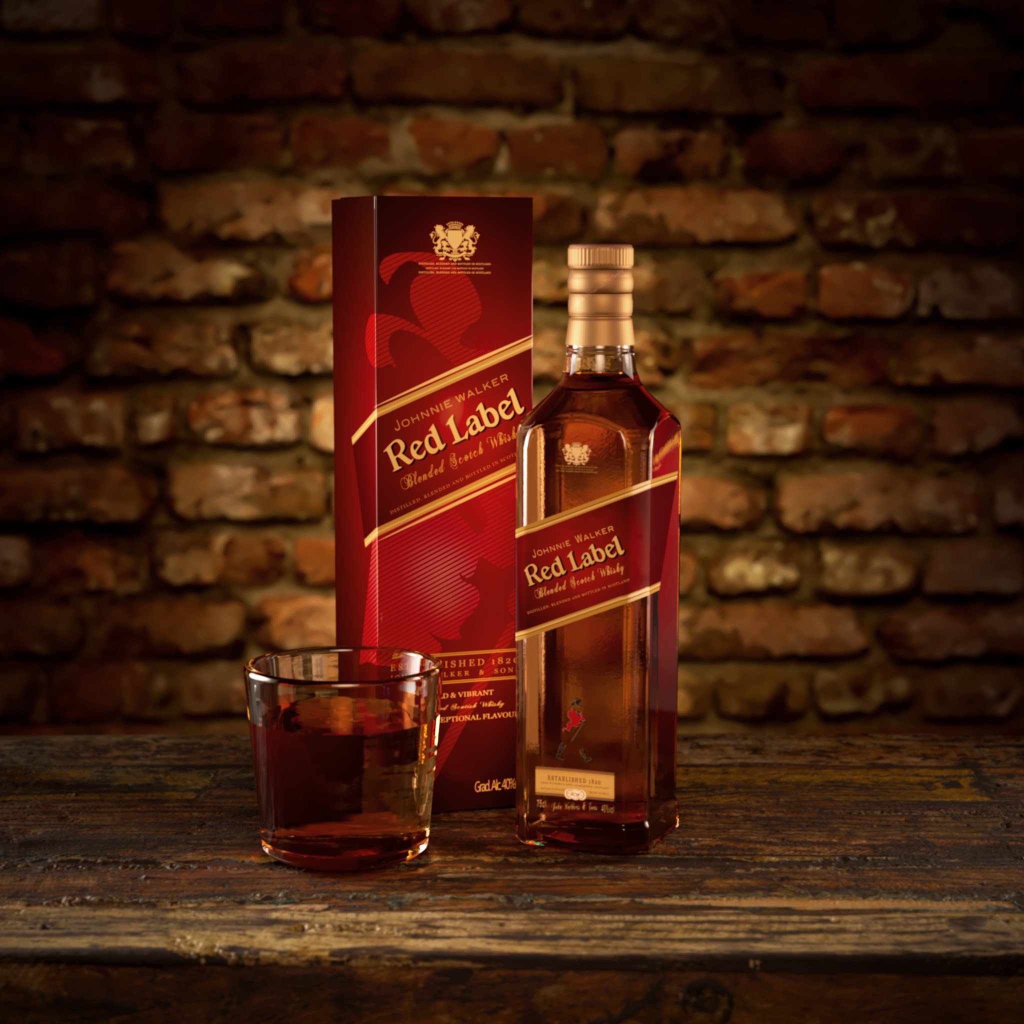 A bottle of Johnnie Walker Red Label blended Scotch whisky with a glass of whisky in front of a brick wall.