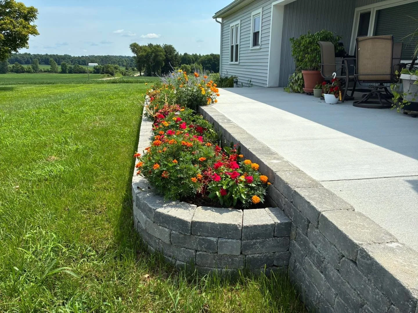 Hardscape stone flower bed in residential outdoor living space near Terre Haute Indiana