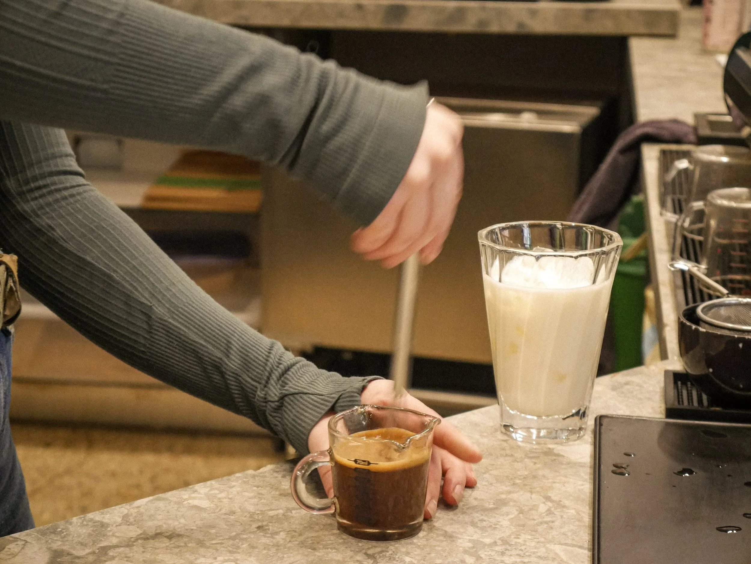 Barista whisking mocha for iced mocha latte