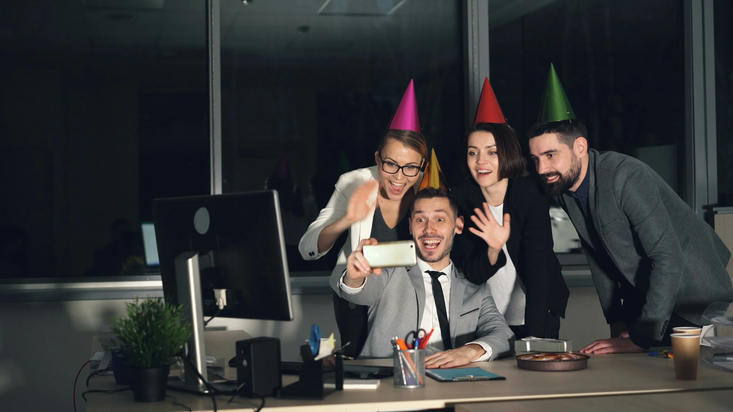 Knowledge management workers huddle infront of a computer monitor taking a selfie in incorrect celebration a Forbes headline appearing to vindicate the role of KM.