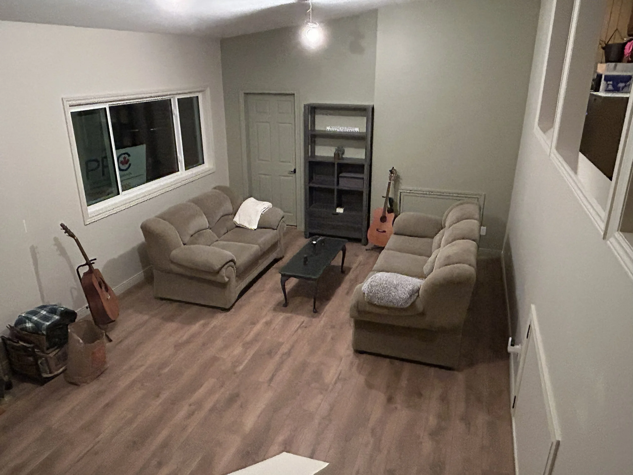 Renovated living room with hardwood flooring and fresh white walls – Bogart's Fine Finishing Campbell River
