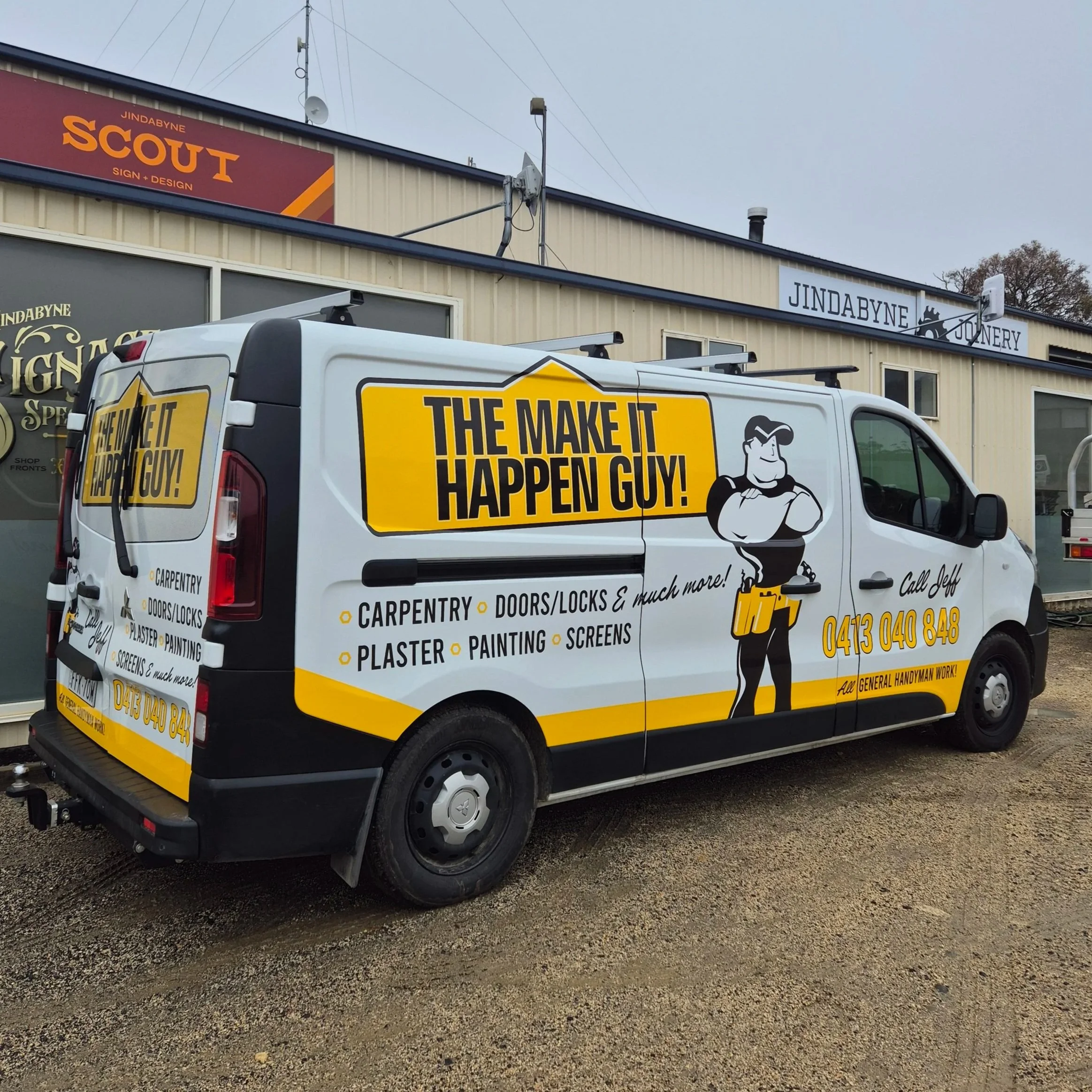 Company van for The Make It Happen Guy, parked outside a building. The van has graphics including a cartoon man with a tool belt, and text advertising services like carpentry, doors/locks, plaster, painting, and screens. The company's phone number is 0413 040 848.