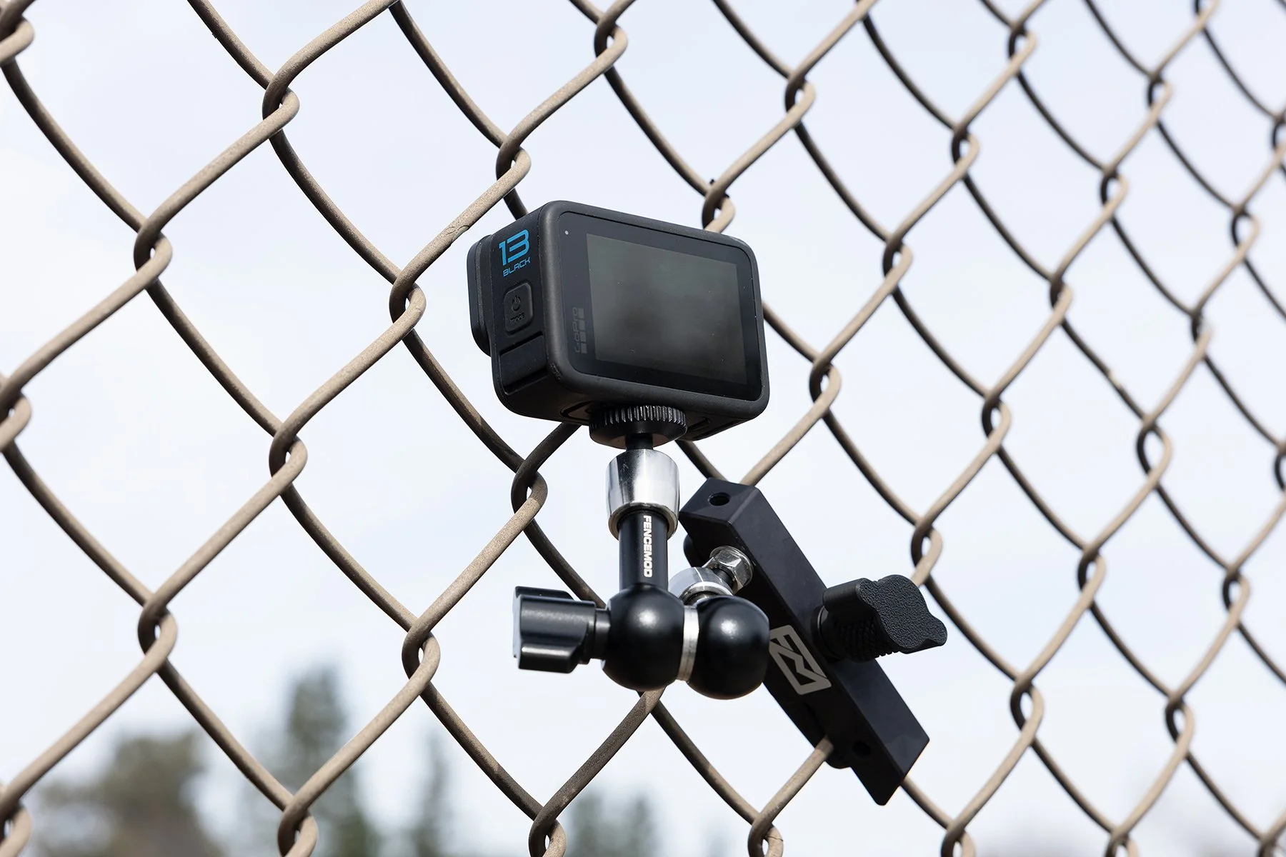 This image shows the Fence Mod Chain Link Fence Camera Mount on a fence with a GoPro Hero Black 13.