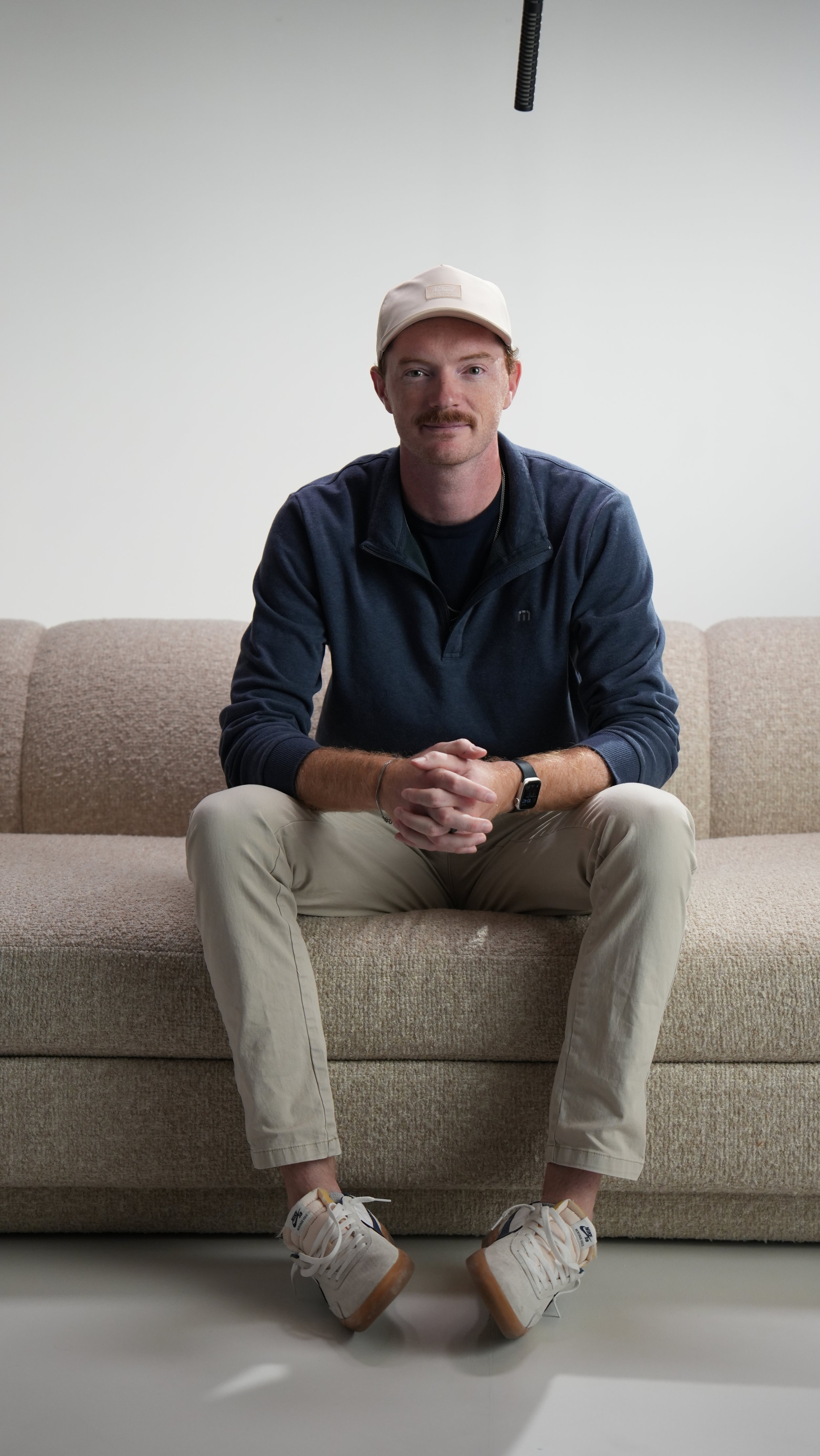 Producer and director, Mark, sits on set during a commercial video shoot