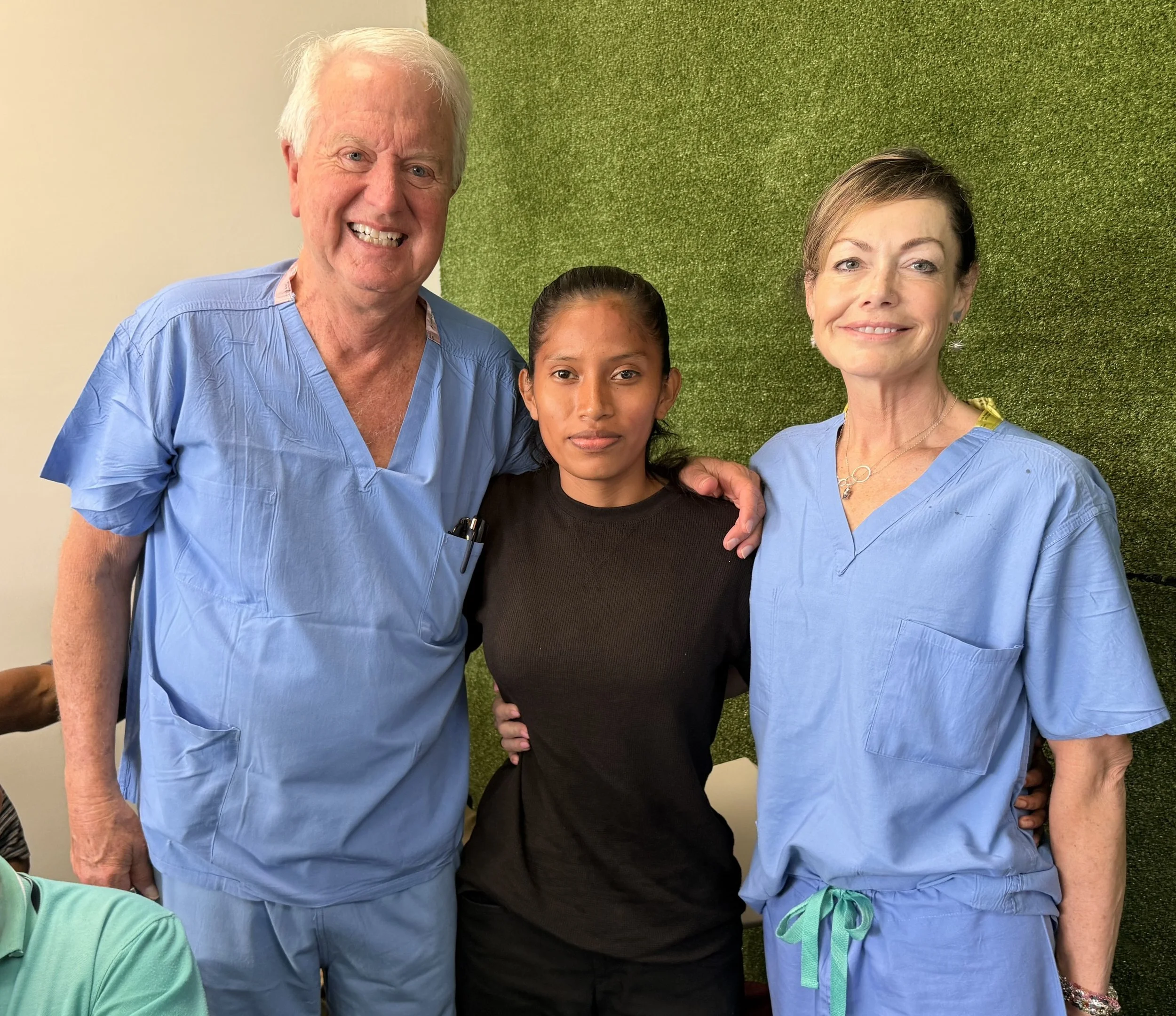 Doctor Burcham, Nurse and our lovely young patient feeling better post cataract removal.
