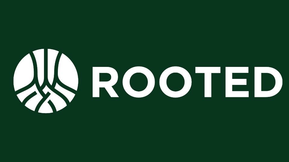 Logo with a circle featuring a stylized tree root and the word 'ROOTED' in white capital letters on a dark green background.
