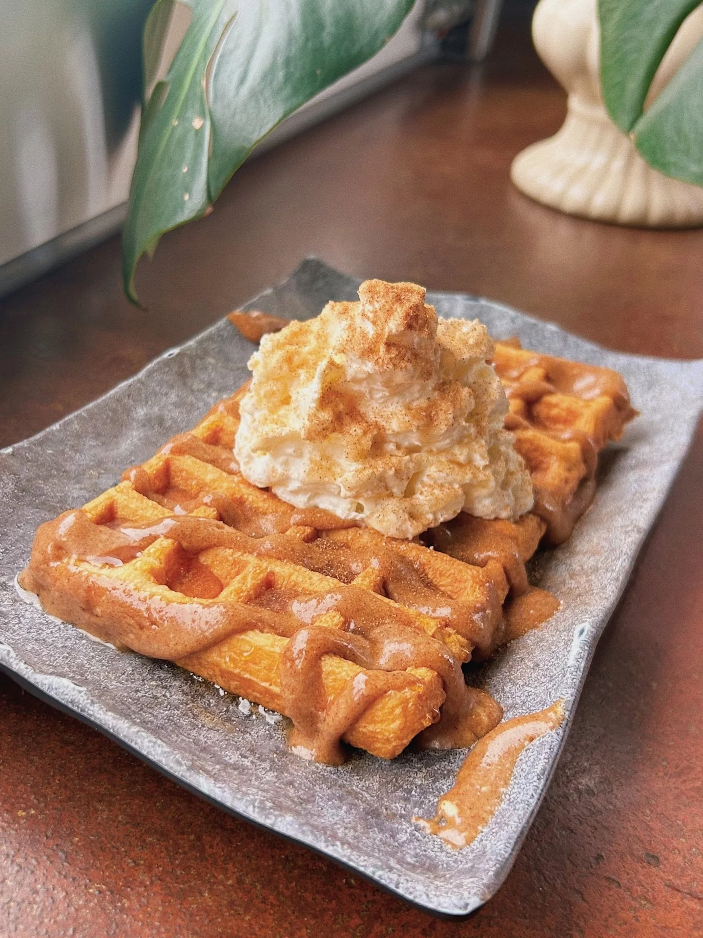 the cinnamon roll waffle is back 👹!! our signature cinnamon roll cream cheese frosting topped with whip and even more cinnamon sugar 🧇 iykyk