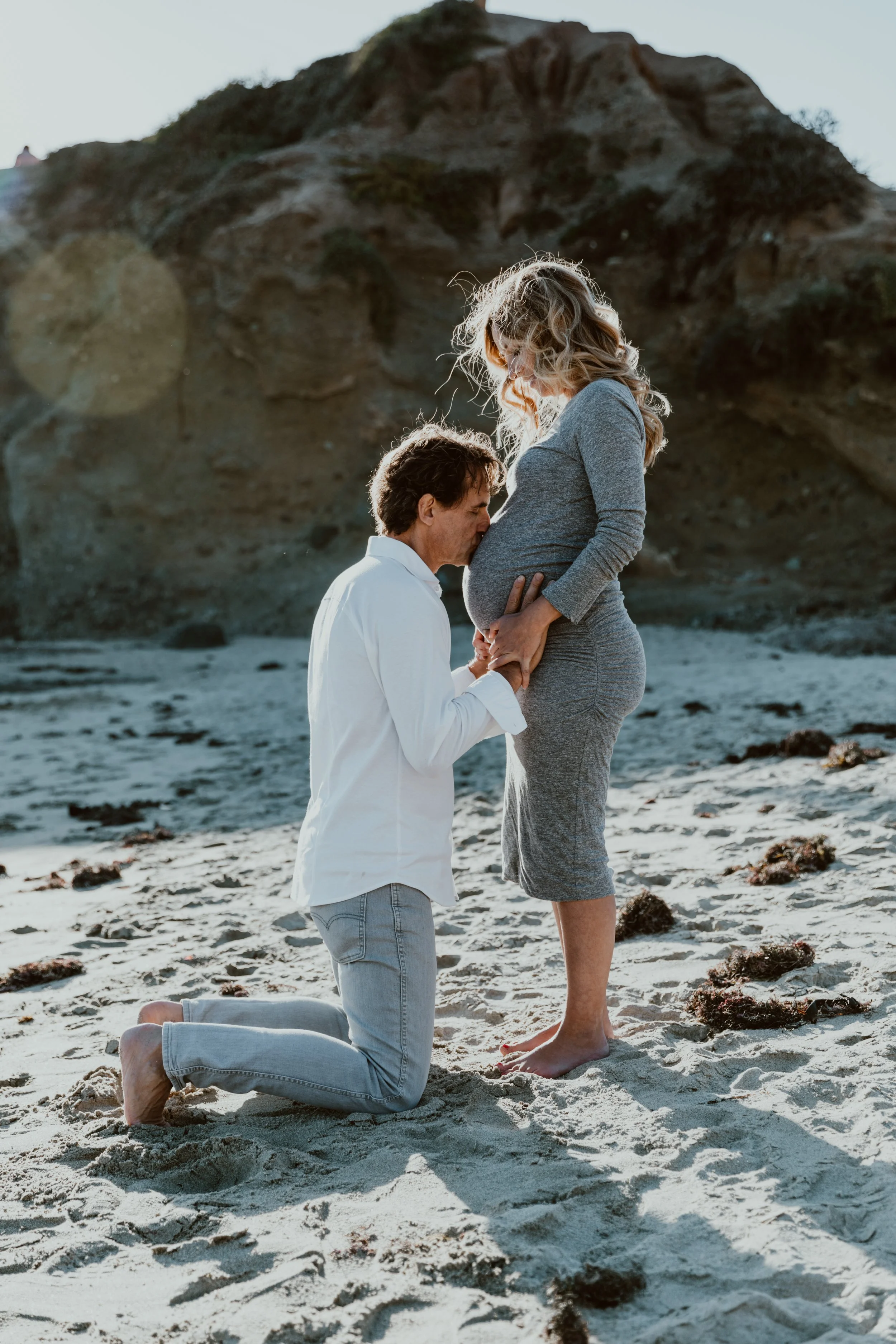 Maternity portraits featuring expecting parents photographed with soft, natural light.