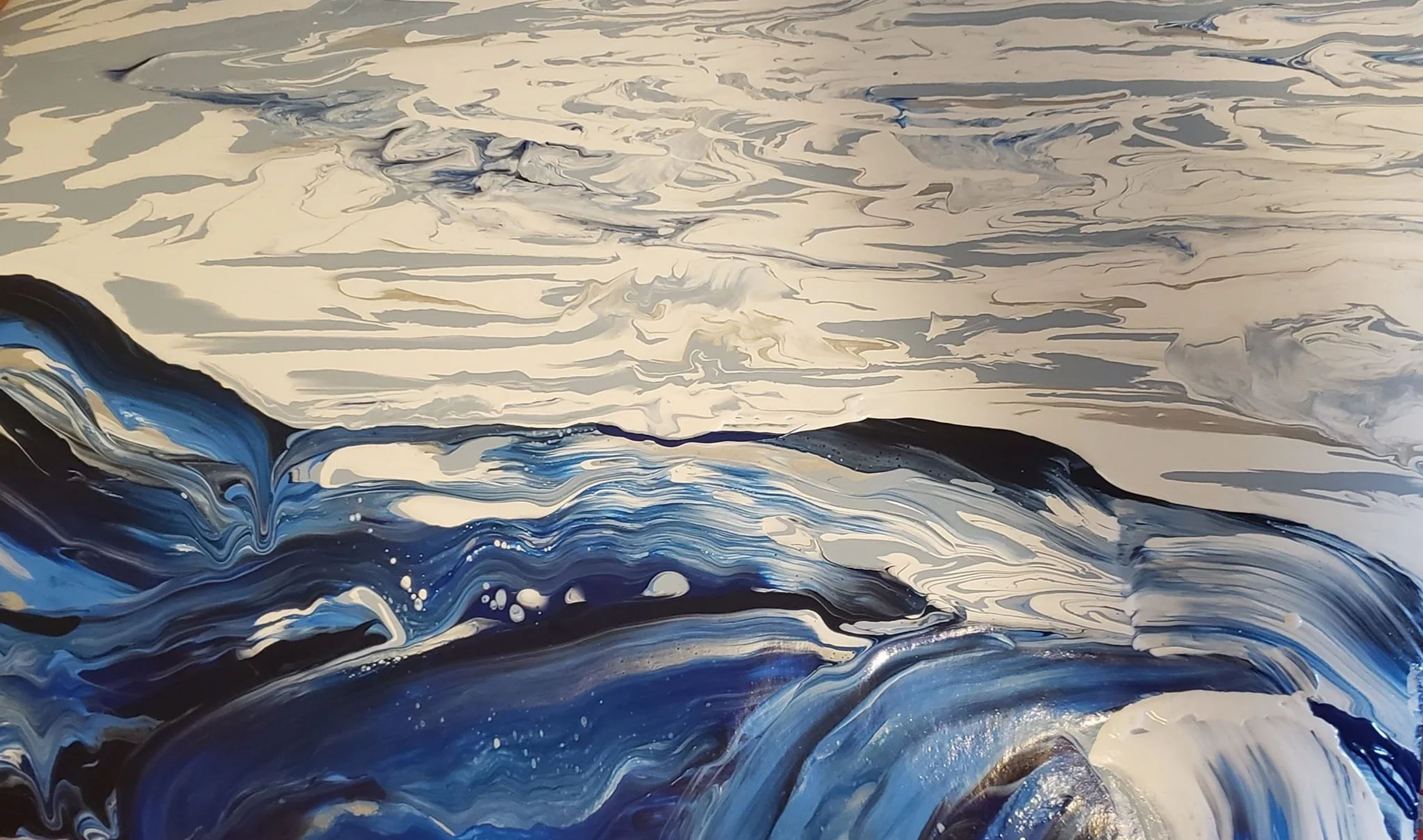 Abstract painting with swirling patterns in black, white, gray, and shades of blue, resembling ocean waves or a stormy sea.