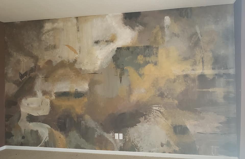 Abstract wall mural with muted colors and textured brushstrokes.