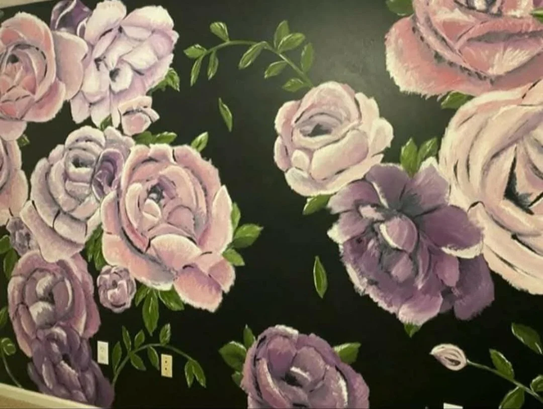 Floral wall mural with pink and purple roses and green leaves against a dark background.