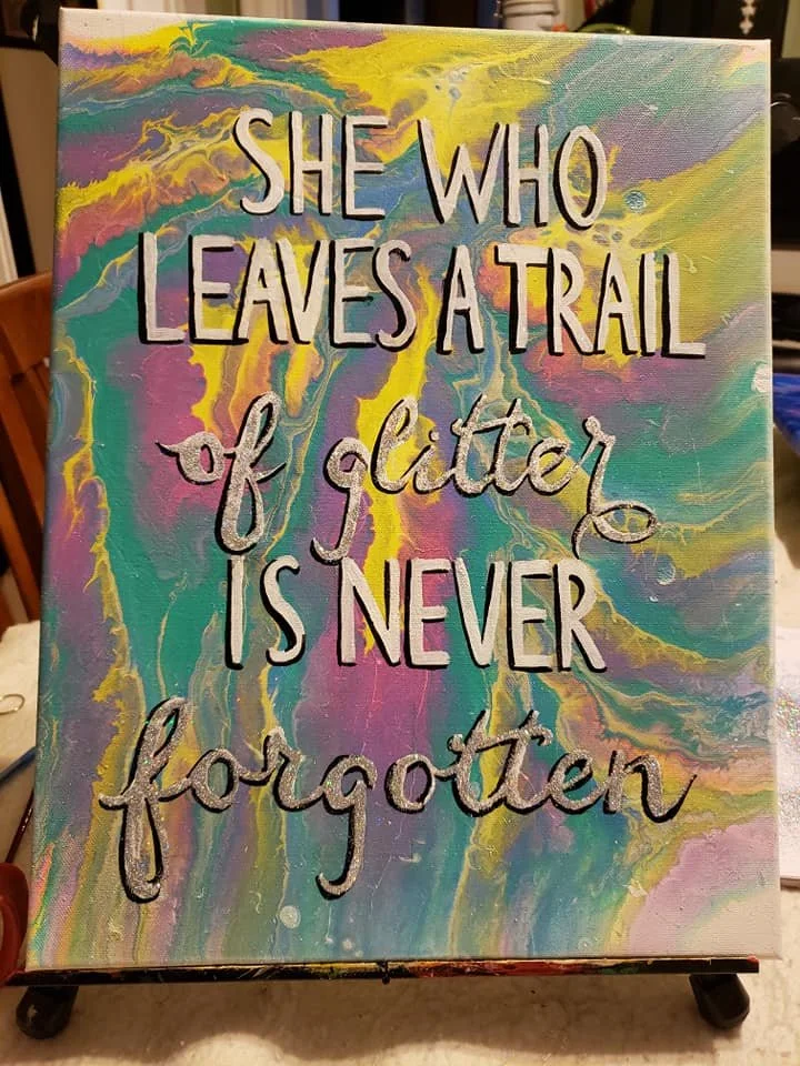 Colorful abstract background with the quote, 'She who leaves a trail of glitter is never forgotten,' written in decorative fonts.