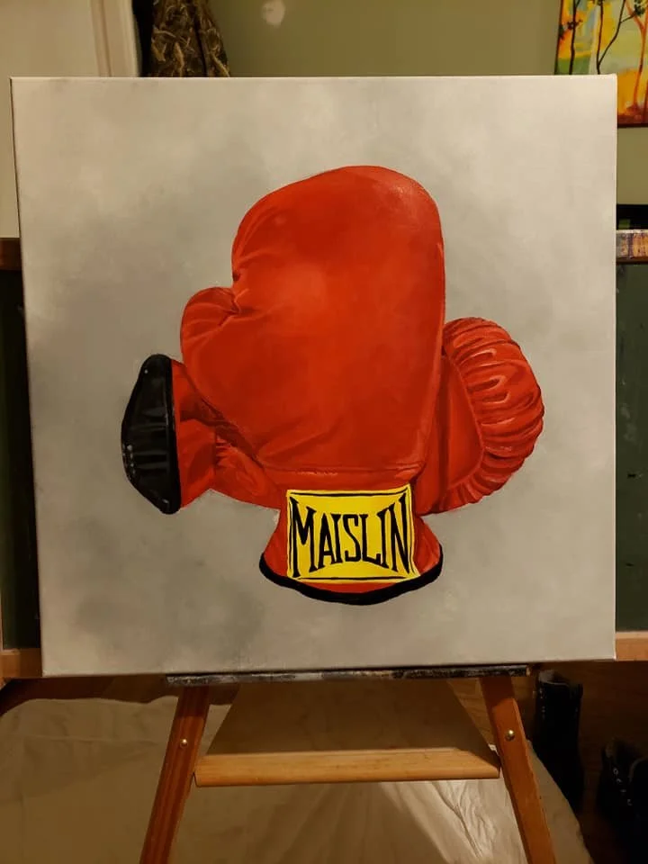 Painting of a pair of boxing gloves, with one glove prominently displayed and the other partially visible, labeled with the brand "MAISLIN."