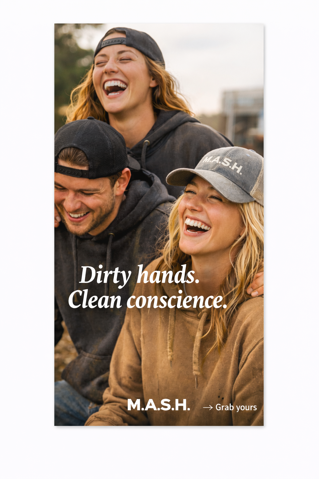 A group of three young adults, two women and one man, laughing and smiling outdoors. One woman is wearing a gray cap with 'M.A.S.H.' written on it, and the others are wearing casual caps. The background suggests they are in a natural or park setting.