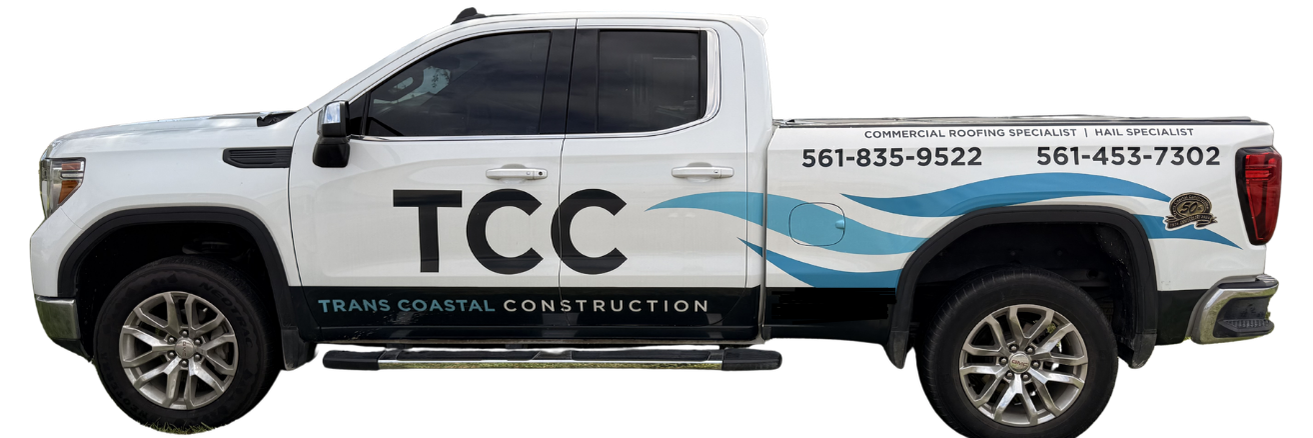 A white pickup truck with black and blue lettering and graphics, advertising TCC Trans Coastal Construction, with contact numbers and a logo on the bed.
