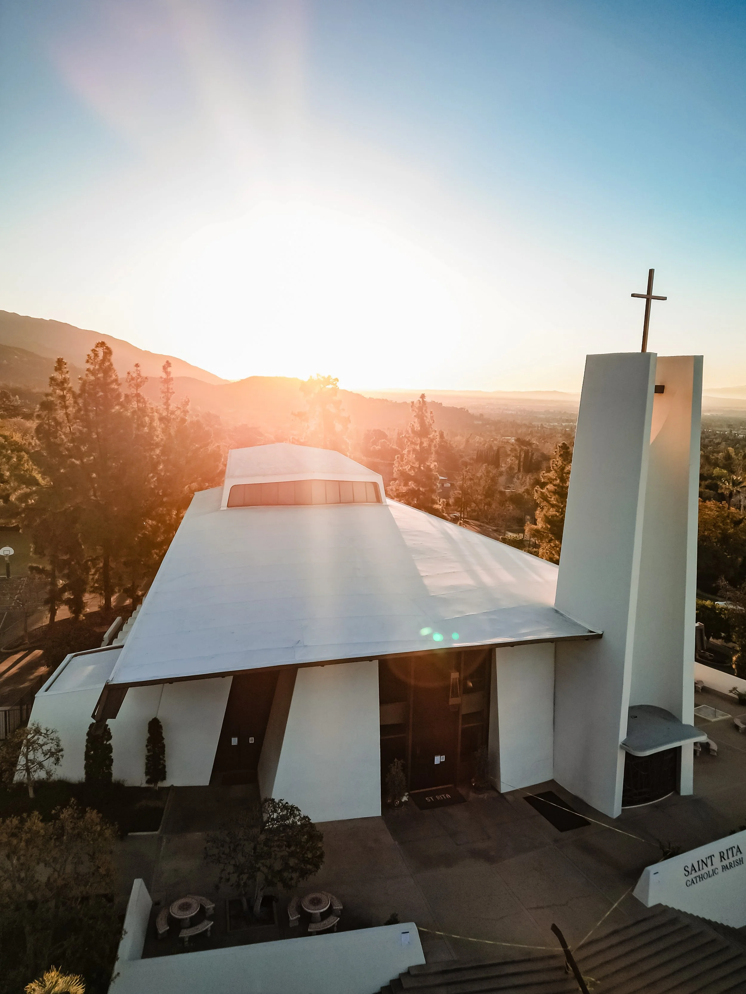 Architectural and commercial photography of a church exterior with steeple and cross at sunset for faith-based organizations, nonprofit marketing, and website use.