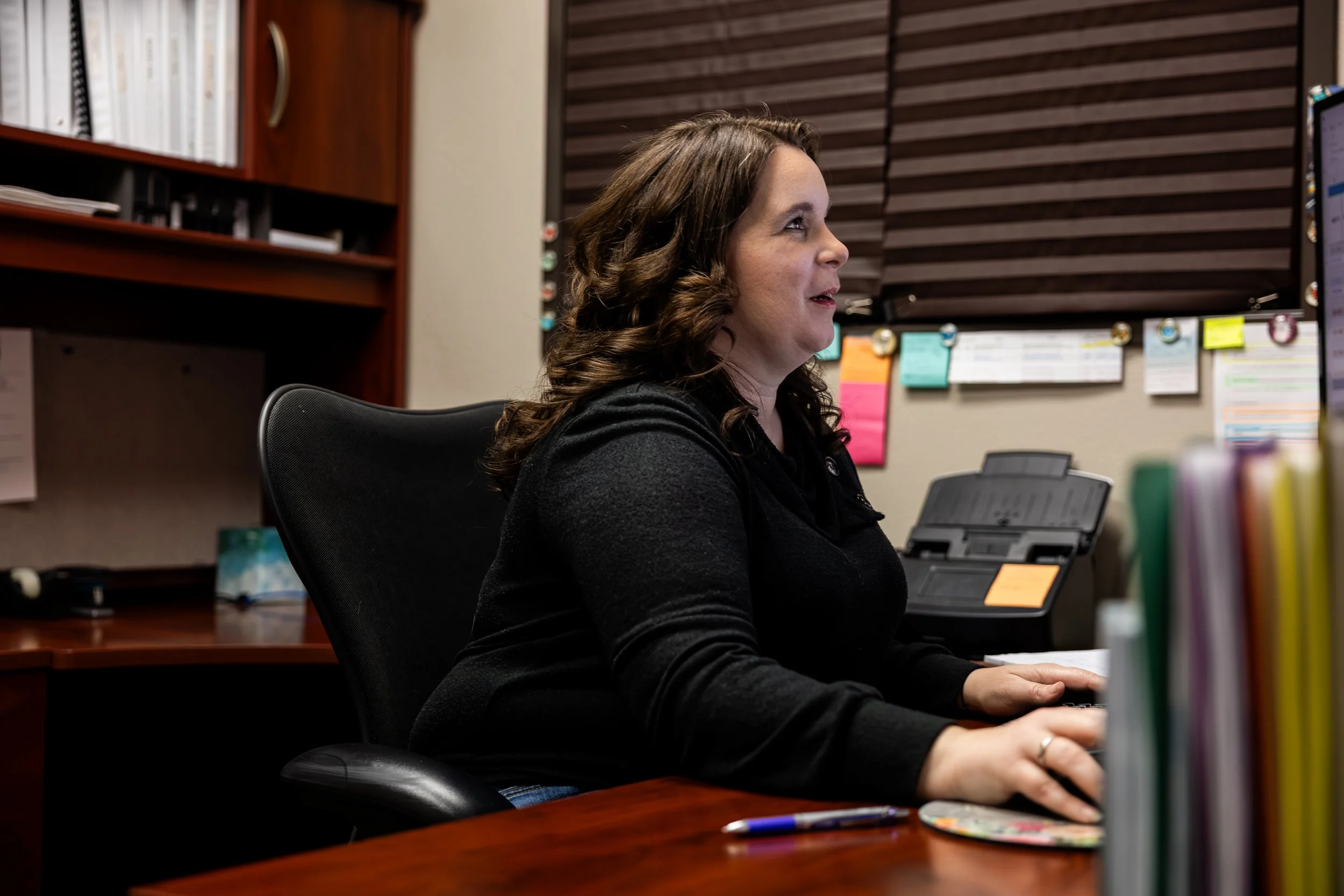 Internal Office photography of a person working at her work statin in Ontario California