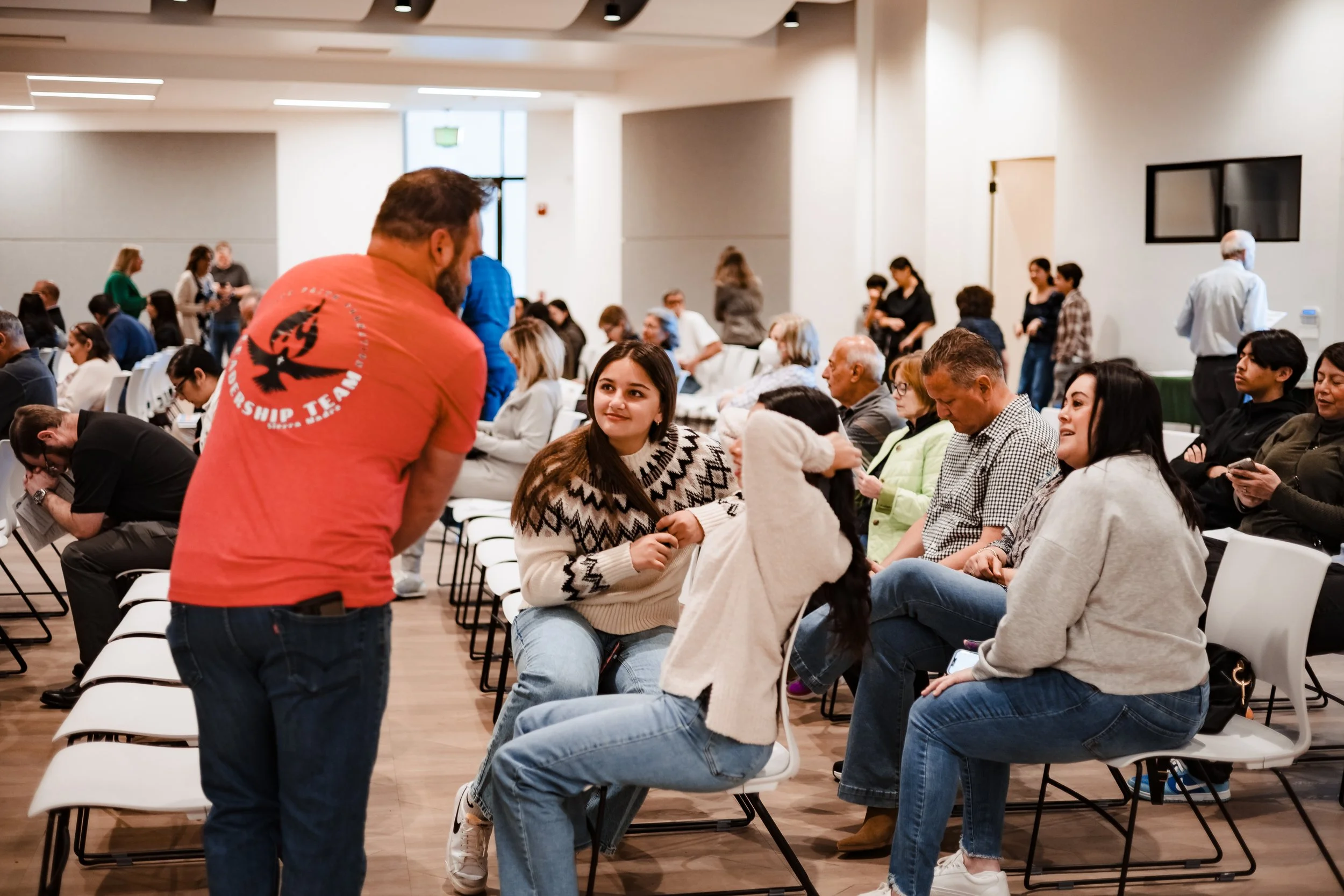 Candid business event photography of audience engagement and interaction during a professional seminar or conference session.