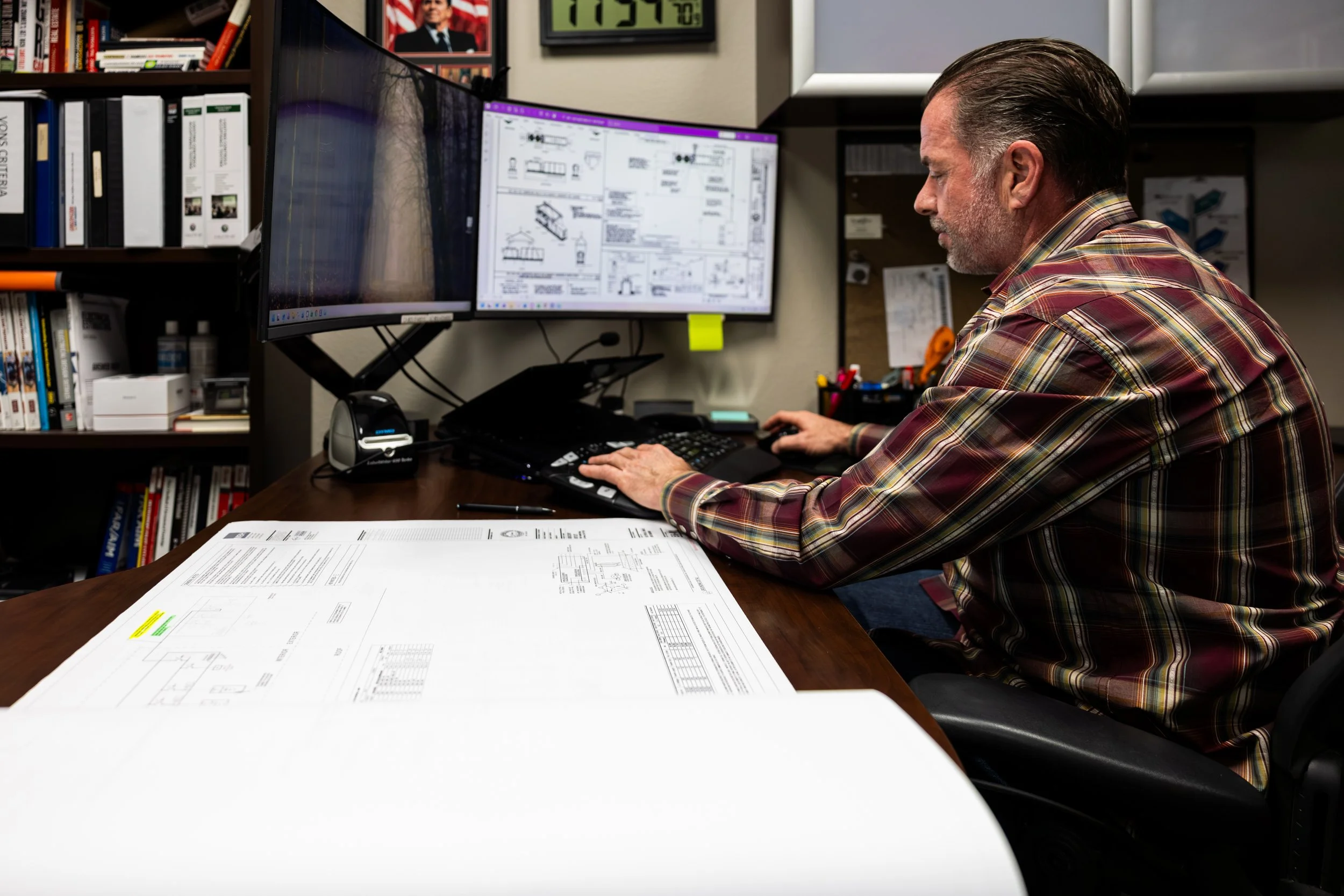 Corporate photography in Ontario Ca of a person working at his desk with building plans