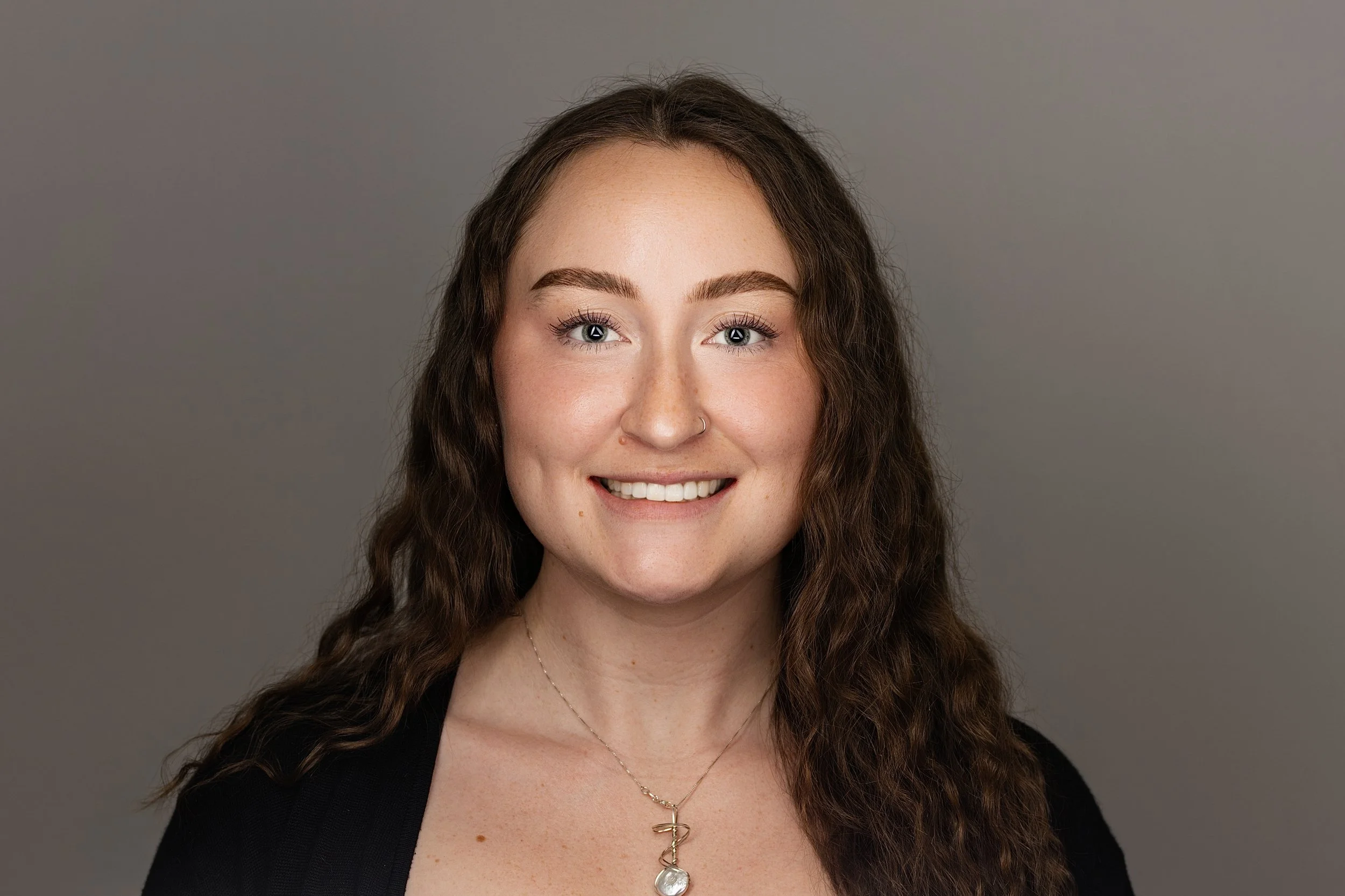 Modern gray-background headshot from on-site volunteer photography for Wounded Warrior Project Tustin, California. Anchor Point Visuals specializes in efficient team headshots for corporate and community organizations.