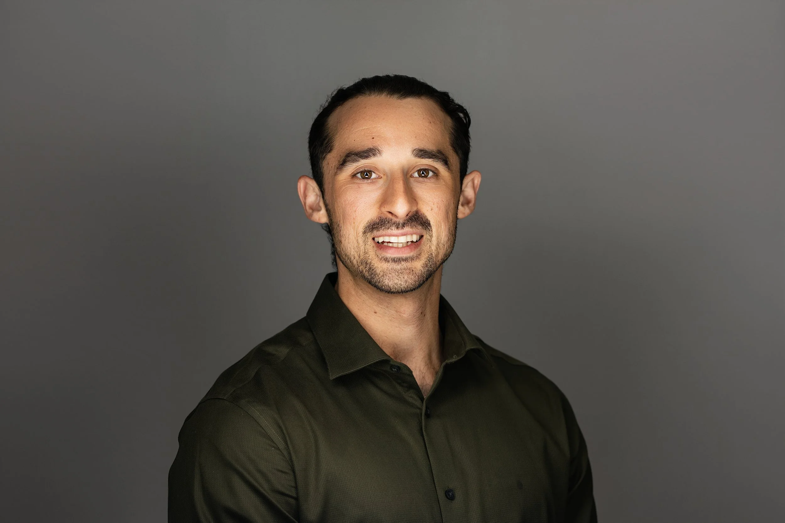 Warm, approachable headshot of a participant in Anchor Point Visuals' free volunteer session for Wounded Warrior Project in Tustin, California. Elevating personal branding for veterans through high-quality on-site photography.
