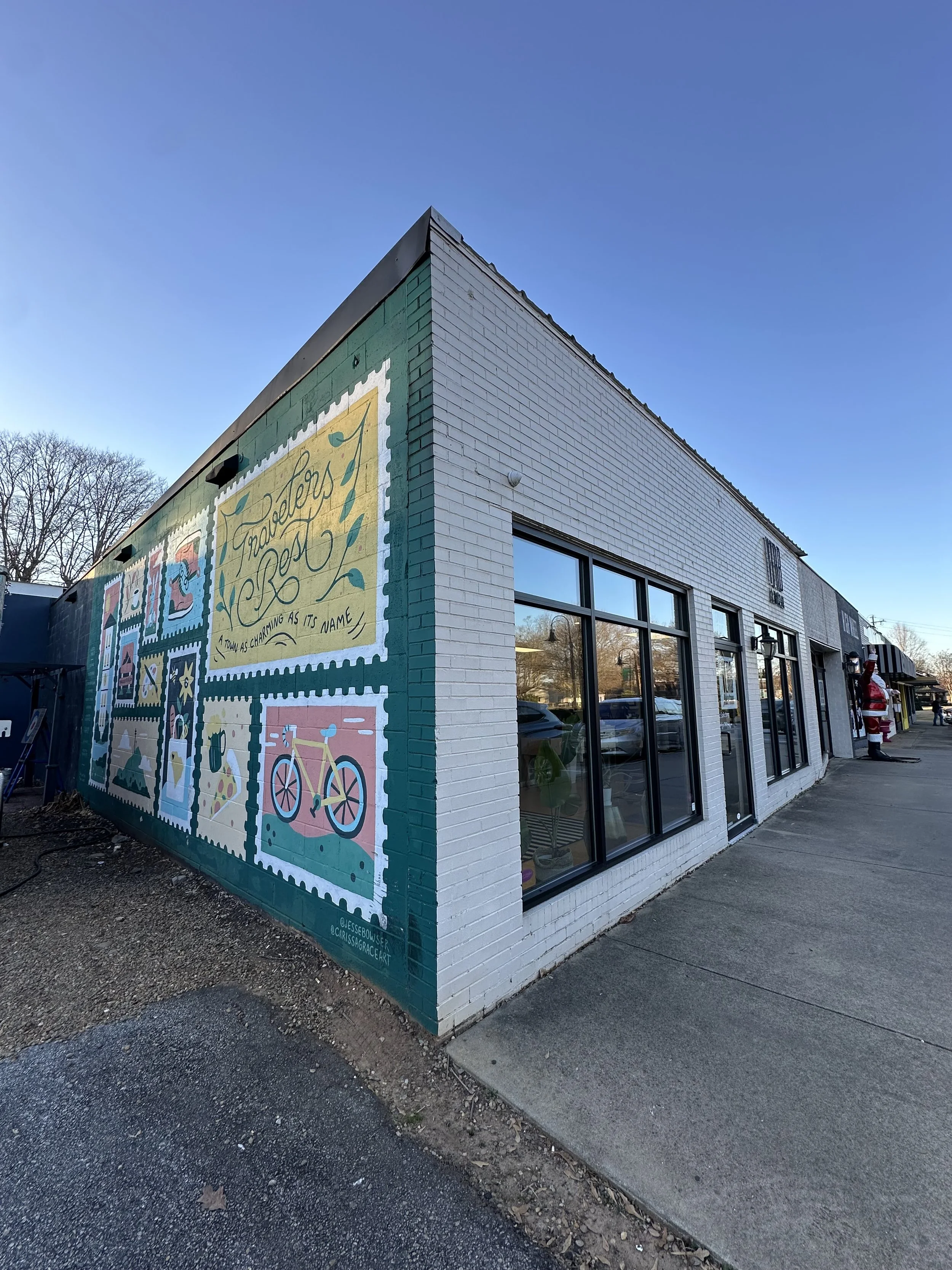 Colorful mural on the side of a white brick building featuring decorative stamps with 'Together as it's name' written on one and a bicycle illustration.