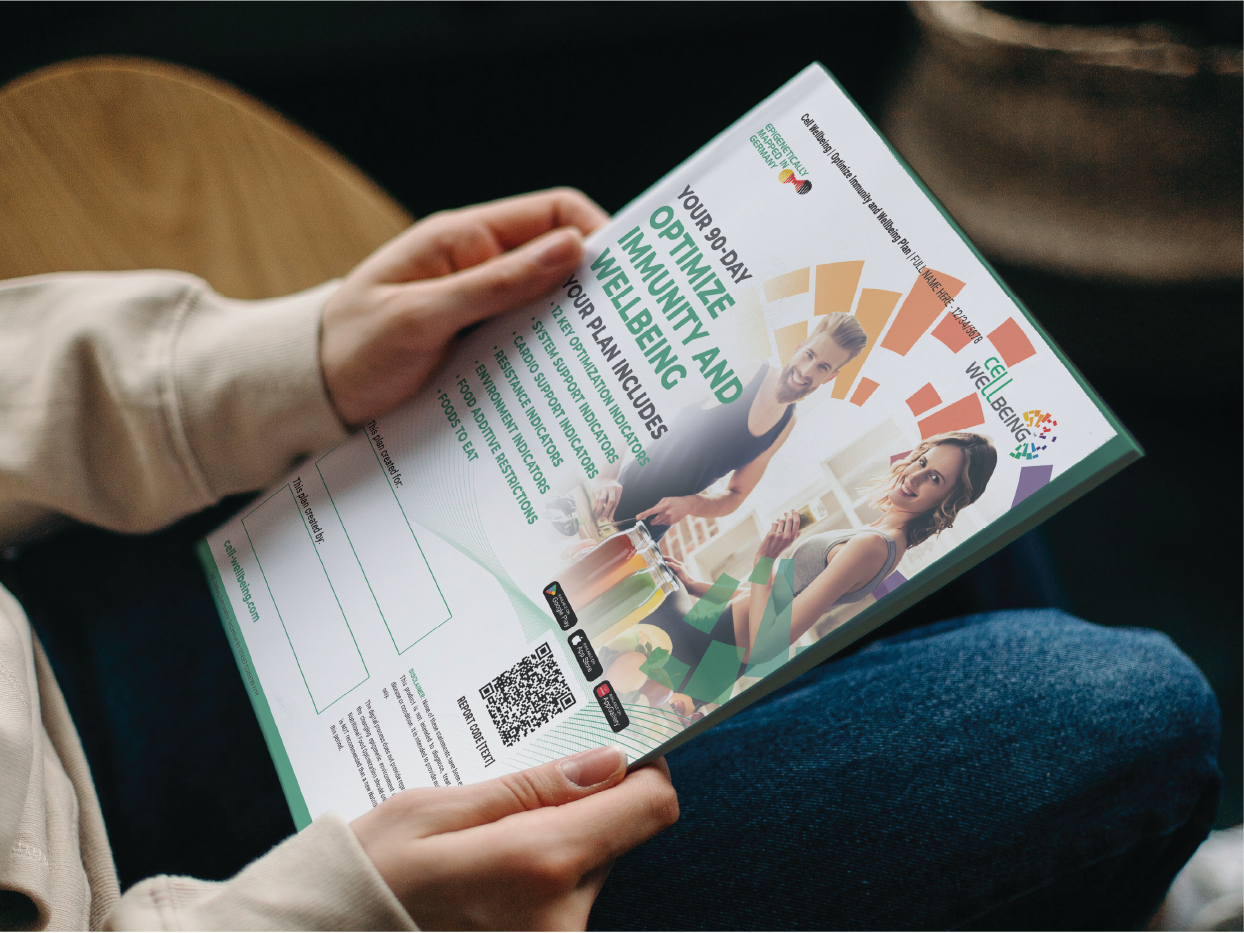 A person holding a colorful pamphlet titled "Your 90-Day Optimize Immunity and Wellbeing Plan" with images of a man and a woman smiling, surrounded by various graphics and text related to health and wellness.