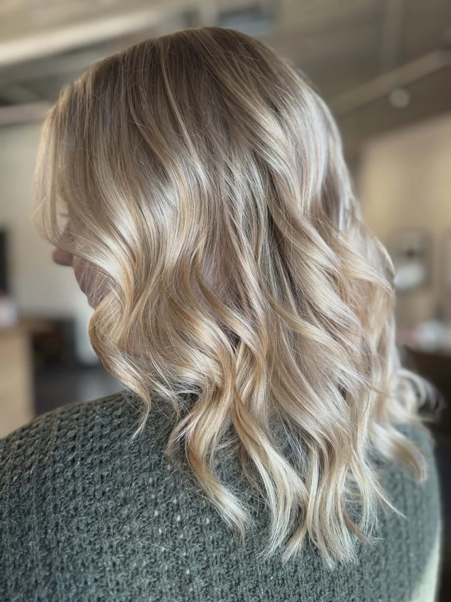 Blonde, shoulder-length, wavy hair.