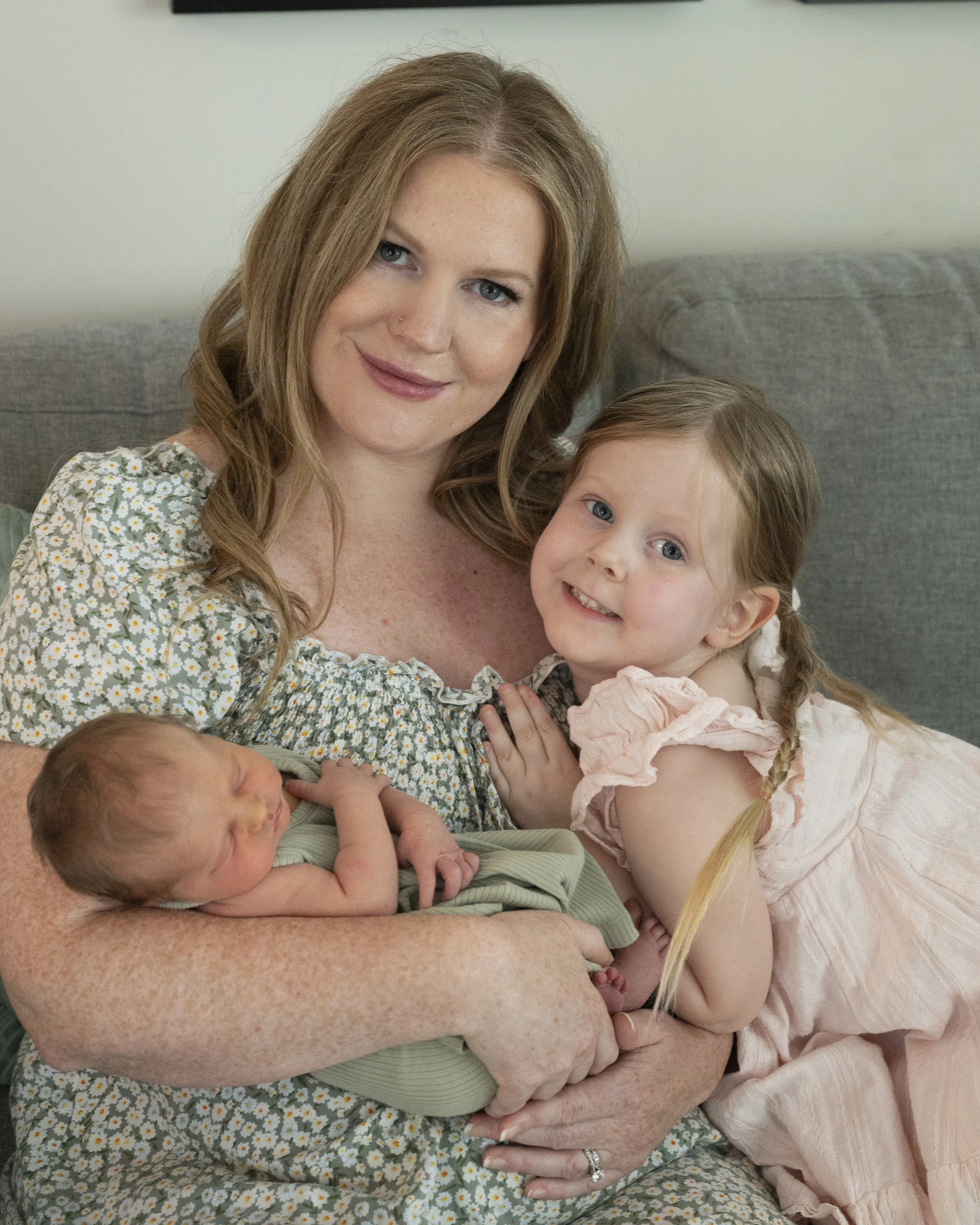 Mother & baby with older sibling feeling supported during postpartum