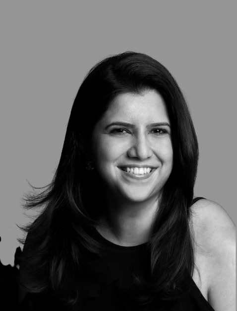 Black and white portrait of a woman smiling, with long dark hair, looking directly at the camera