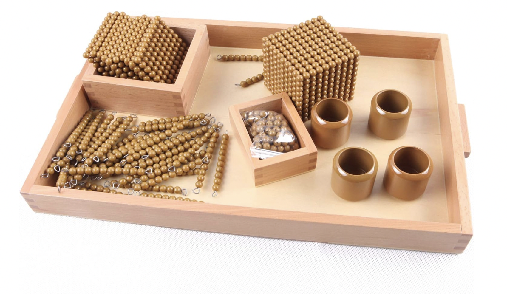 A wooden game box containing beads, chains, and rings used for a traditional game. The box has compartments holding different sizes of beads and chains, along with four hollow cylindrical pieces.