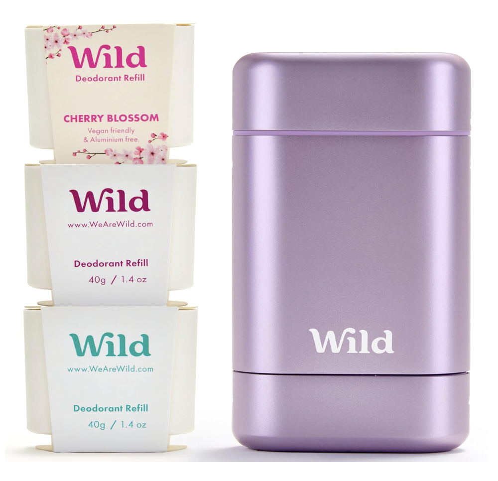 Three boxes of Wild deodorant refills in pink cherry blossom, white, and turquoise colors, next to a lavender-colored deodorant case.