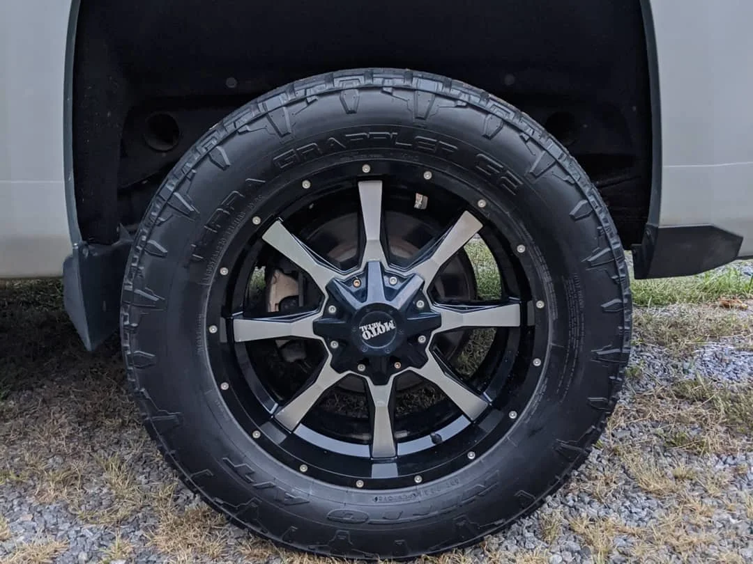 Close-up of a tire and alloy wheel on a vehicle, with the brand 'Method' on the wheel center cap.