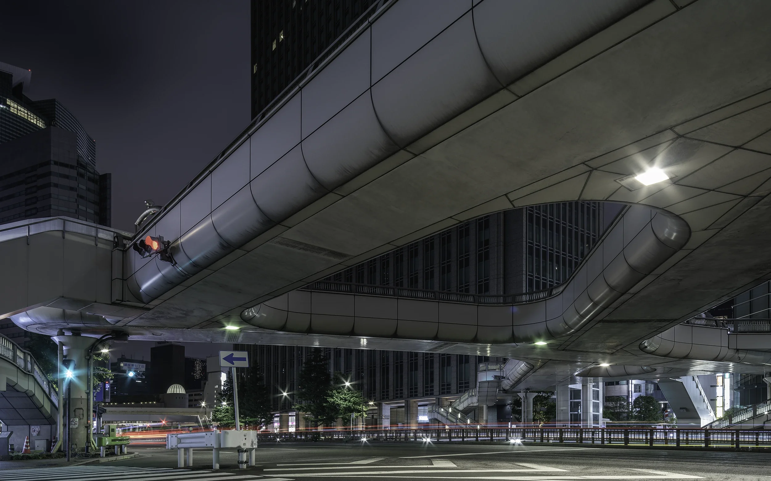 Contemporary pedestrian bridge in Ginza, Tokyo, showcasing clean lines, geometric design and the minimalist elegance of Japanese urban architecture.