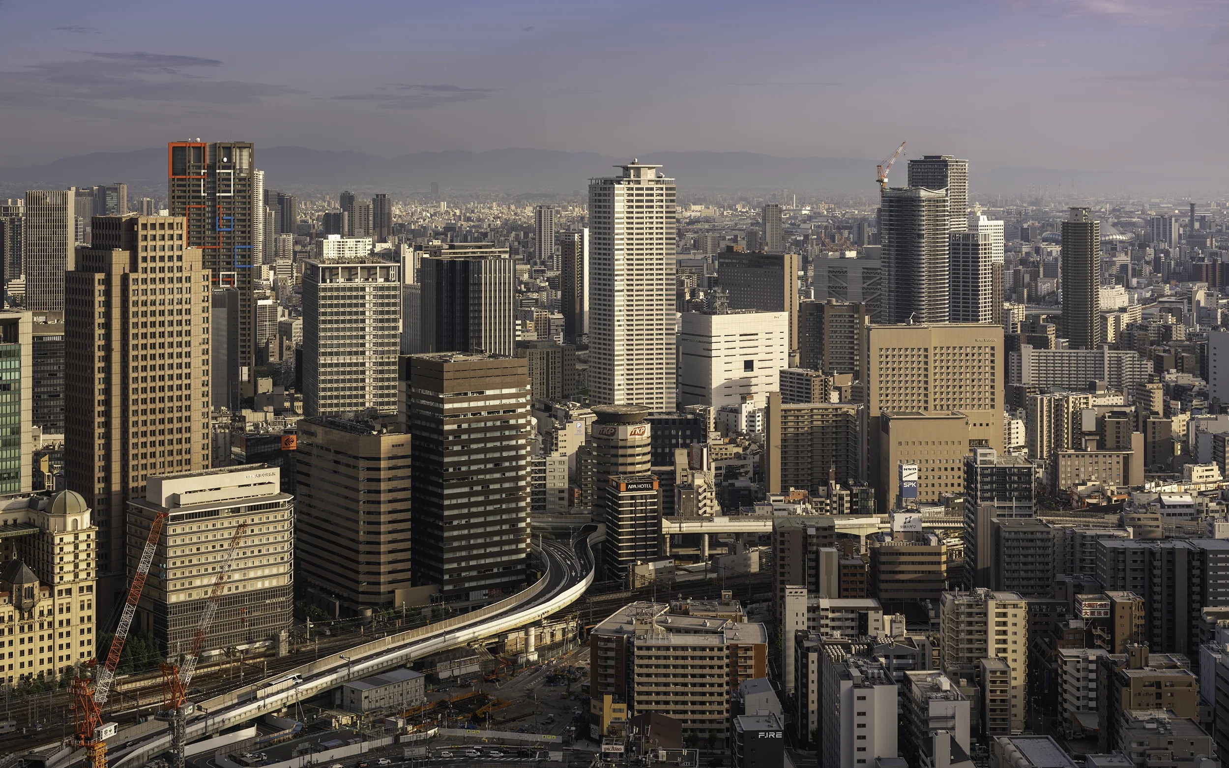Elevated view over Umeda, Osaka's modern business district, where towering skyscrapers, elevated railways and an endless urban skyline reveal the scale of Japan's second-largest metropolis.