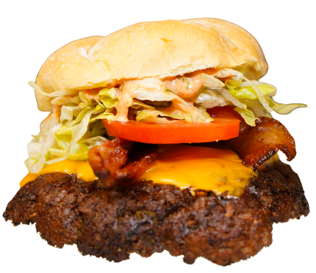 Close-up of a loaded cheeseburger with lettuce, tomato, bacon, melted cheese, a beef patty, and a bun.