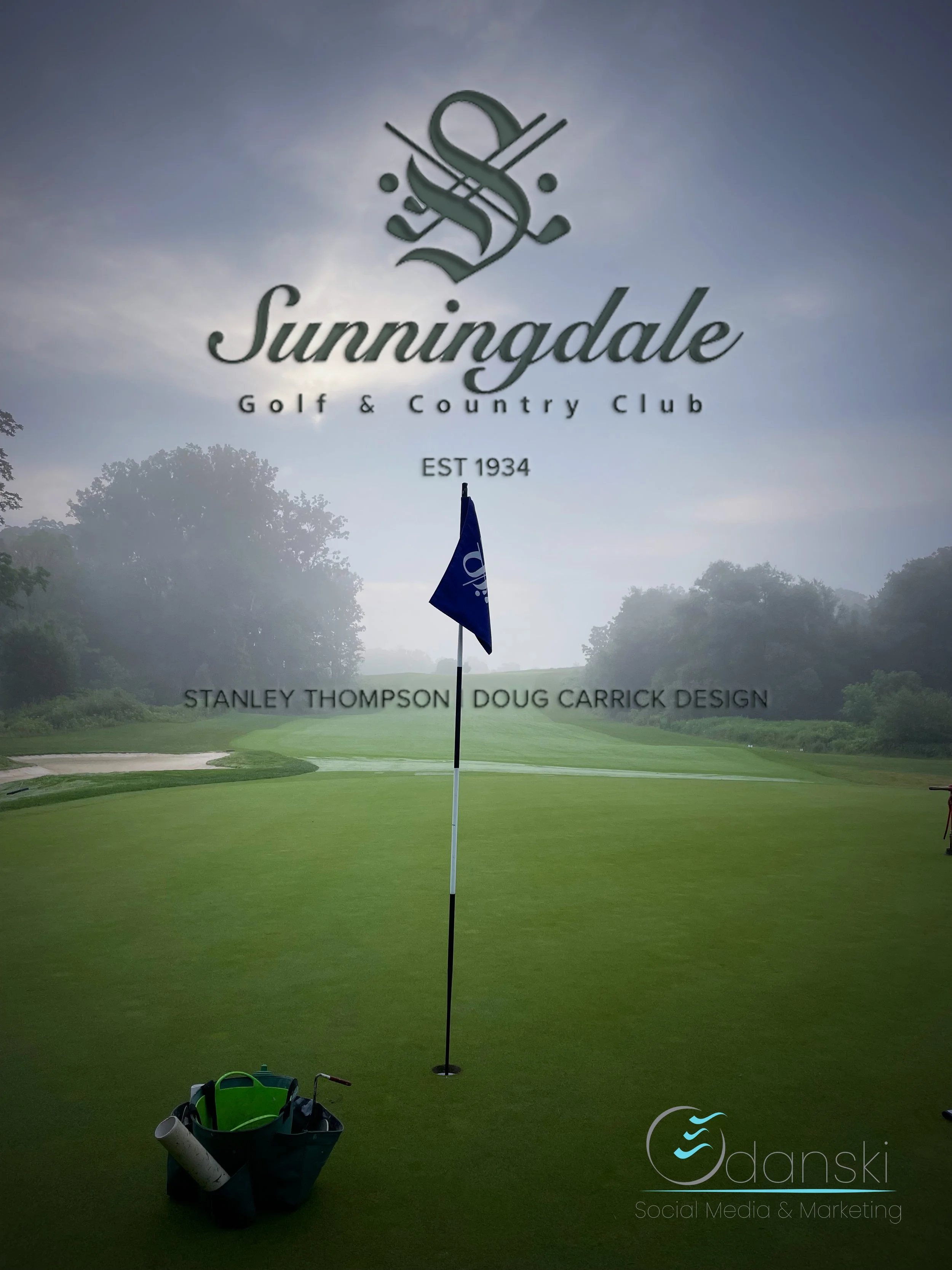 Golf course green with flagstick and flag, golf bag with clubs and accessories, in front of Sunningdale Golf & Country Club sign at dusk or dawn.