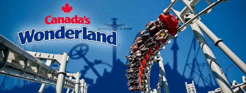 A roller coaster at Canada's Wonderland amusement park with a train of red and black riders on curved tracks, and the park's logo in the background.