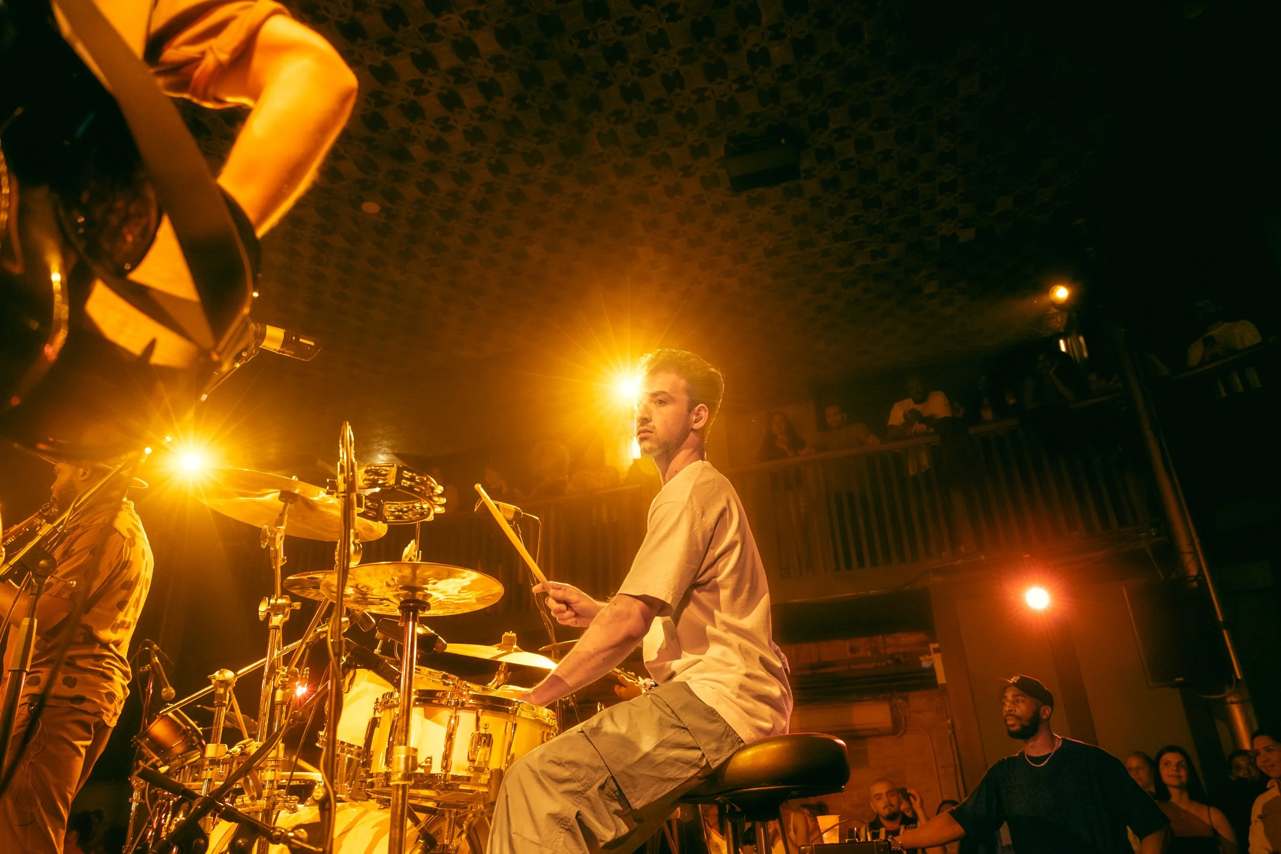 Drummer Miles Johnson playing drums on stage during Davie Studios' Listening Room at Longboat Hall.