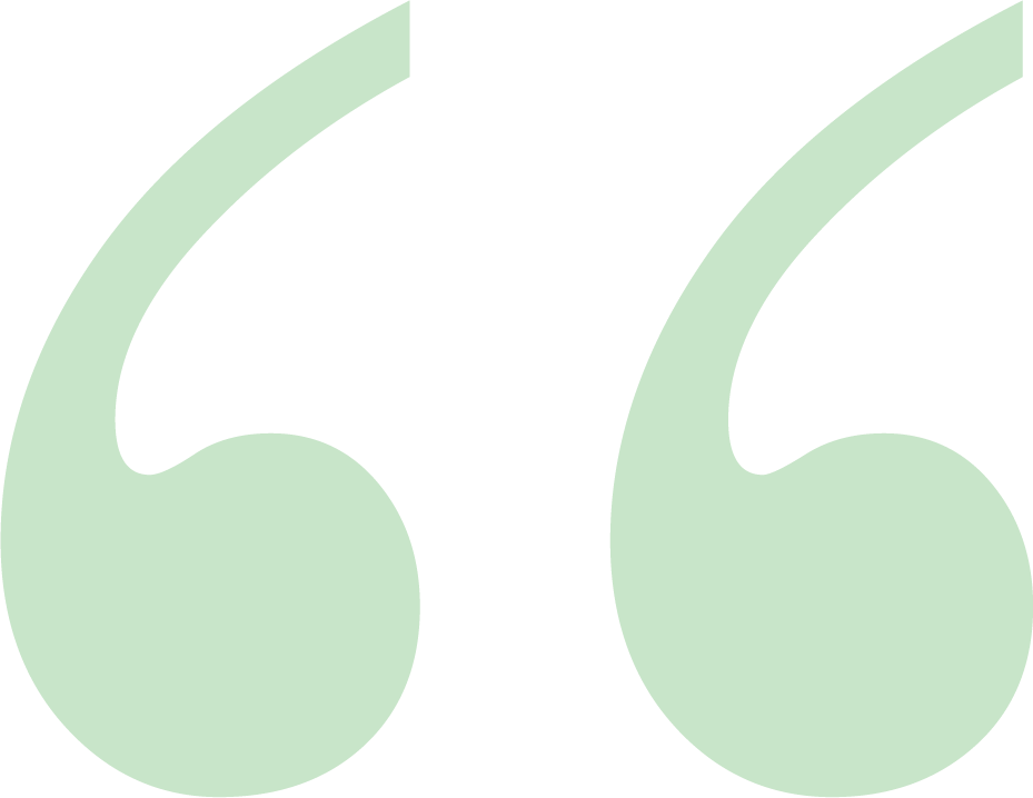 A pair of green quotation marks designed as a background element.