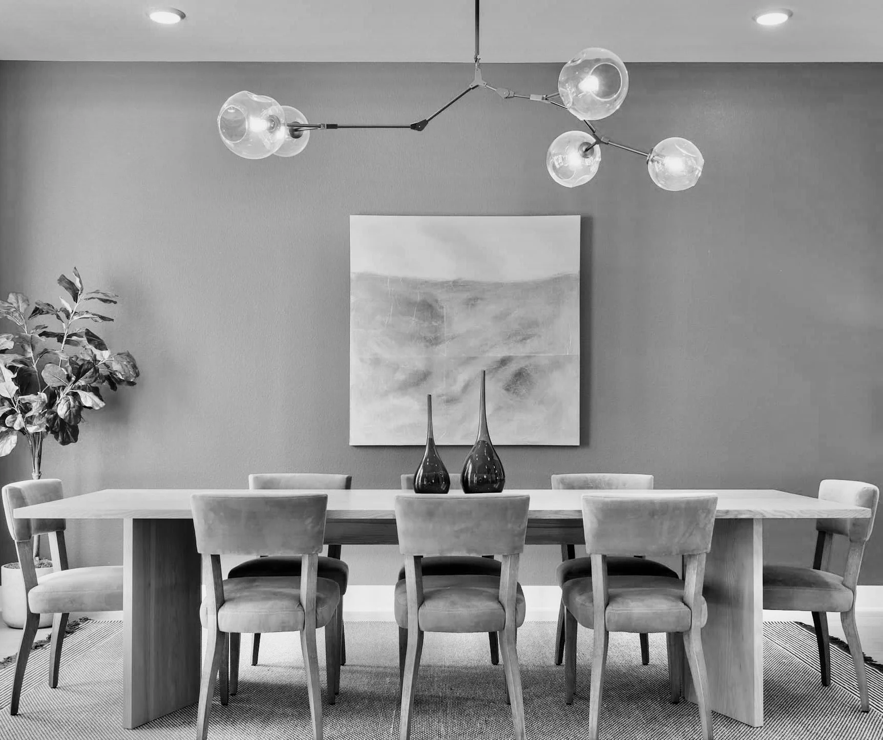 Staged dining room with long table and statement chandelier