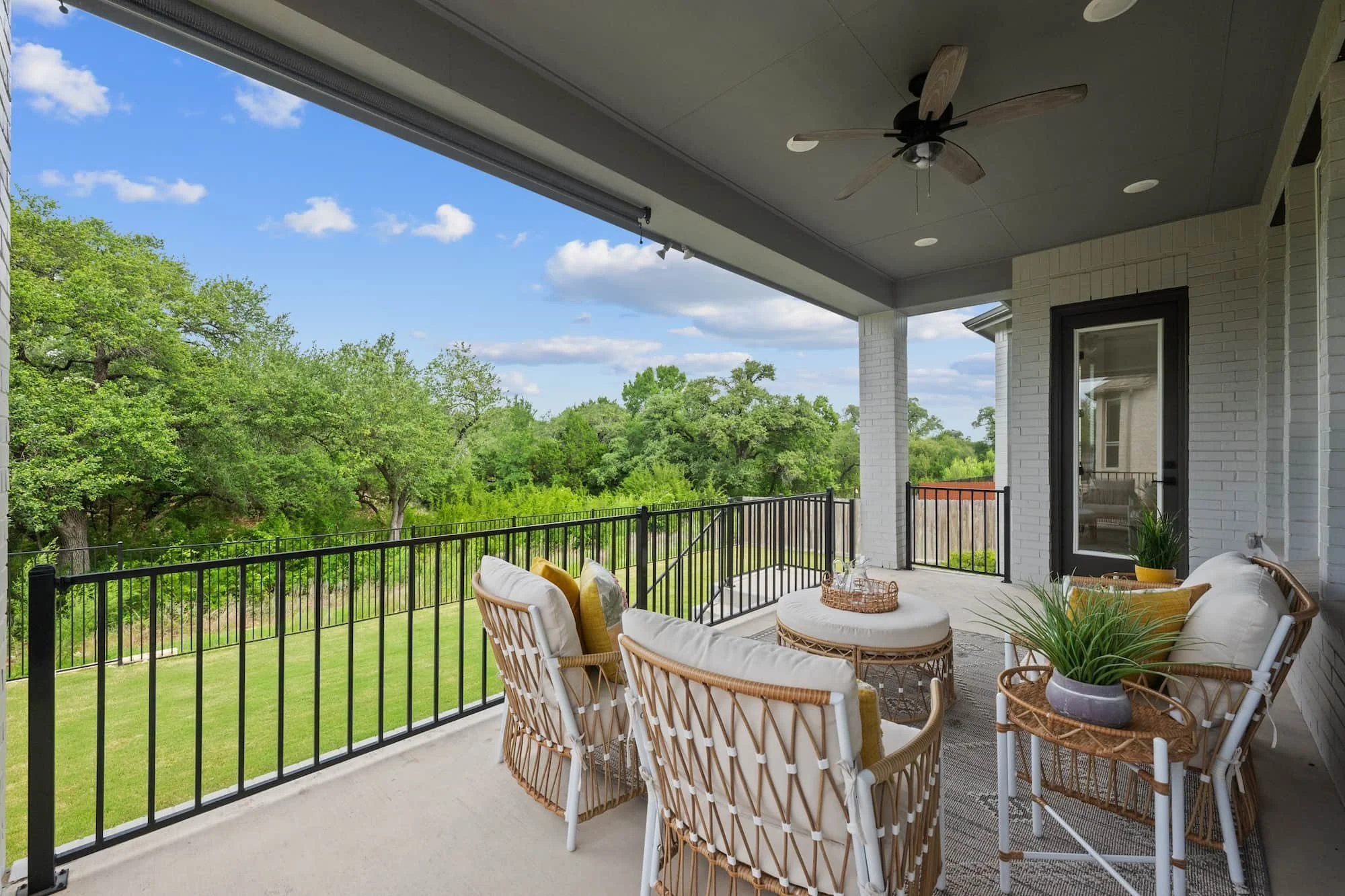Covered outdoor living with serene tree-lined views in Leander, Texas
