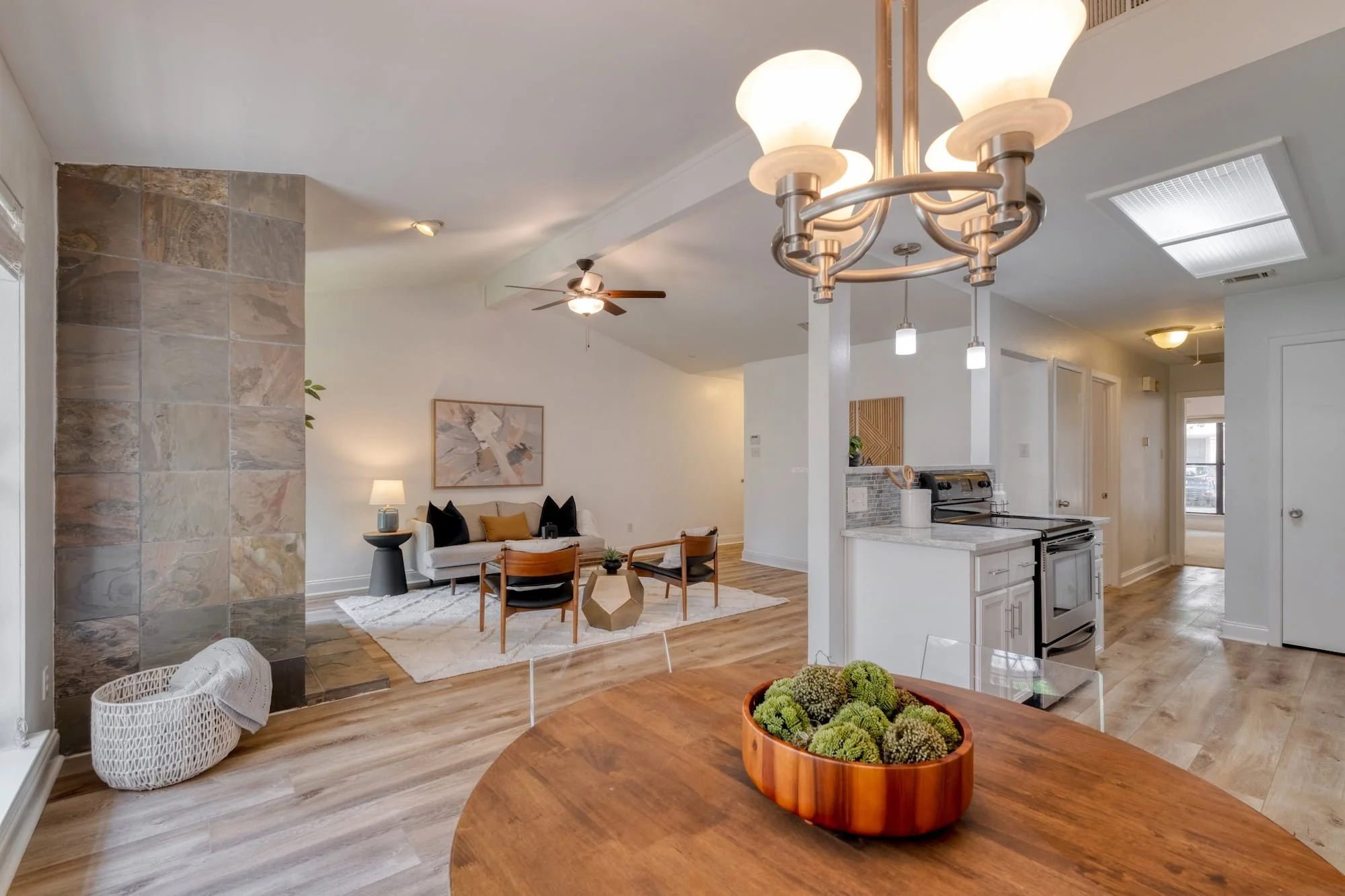 Central Austin open-concept living and dining area with stone fireplace