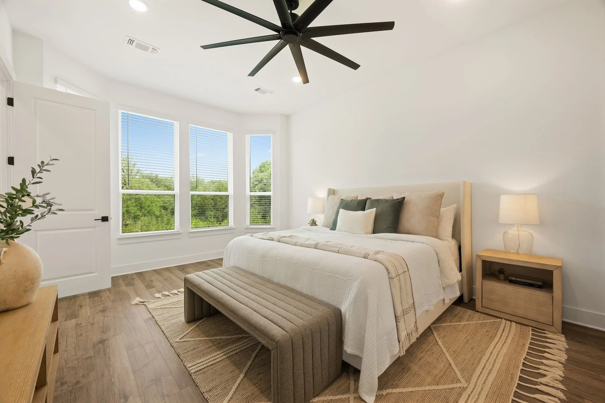 Serene primary bedroom retreat with oversized windows, designer finishes, and abundant natural light