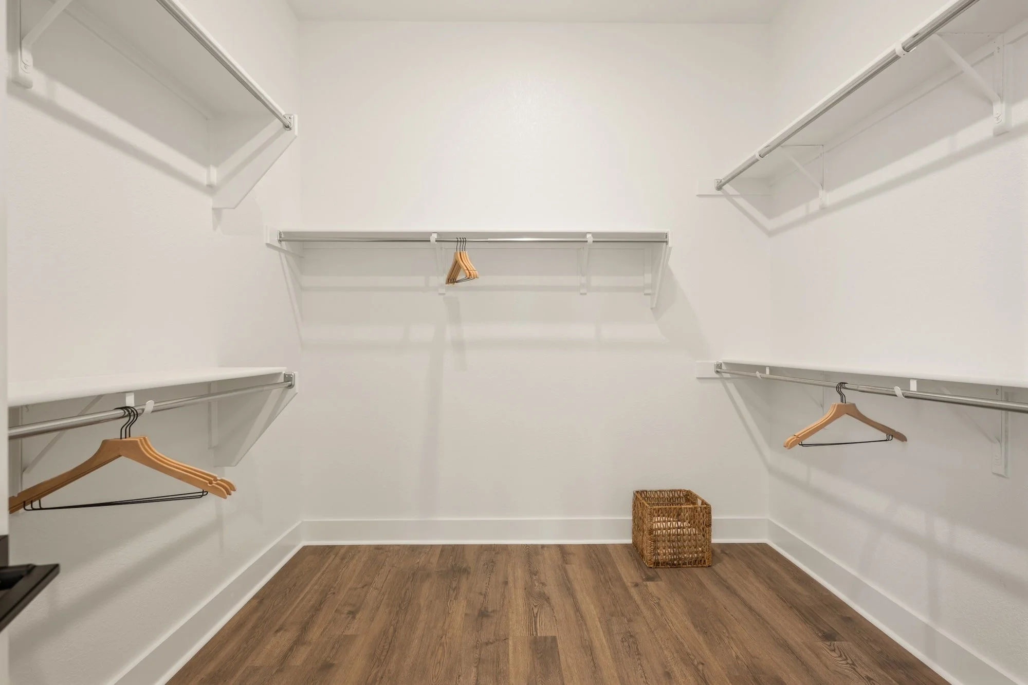 Generous walk-in closet with dual hanging areas and ample storage