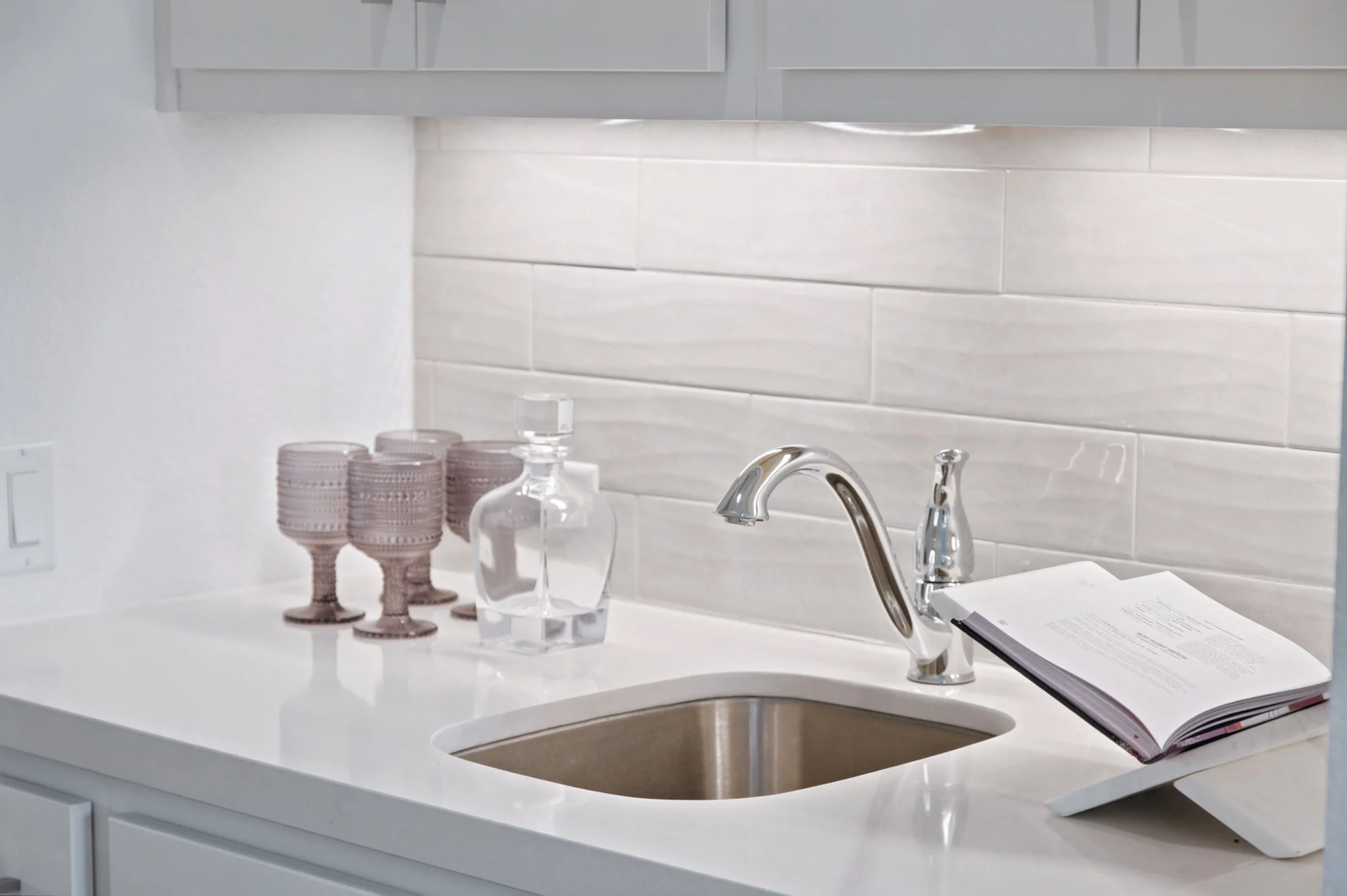 Crystal glassware and a decanter dress the butler's pantry sink for effortless entertaining.